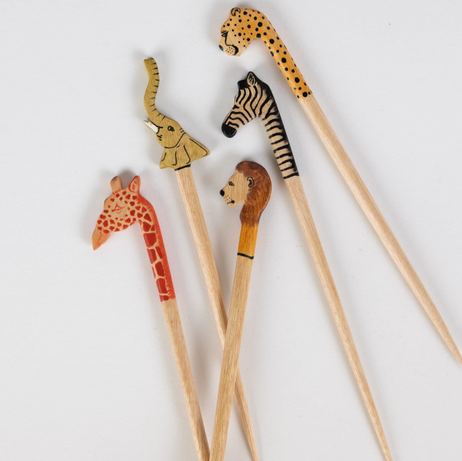 Handcarved wooden elephant stir stick for cocktails, showcasing intricate detail.