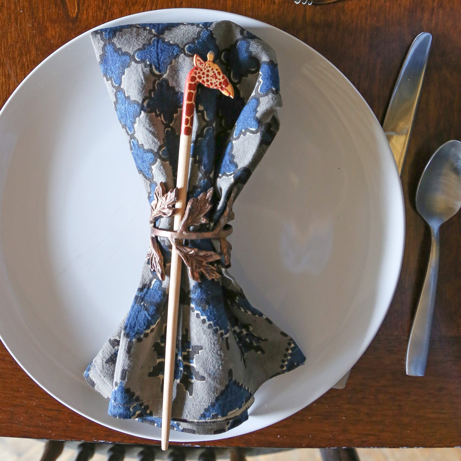 Close-up of handmade giraffe chopsticks made from sustainable jacaranda wood, showcasing craftsmanship and detail
