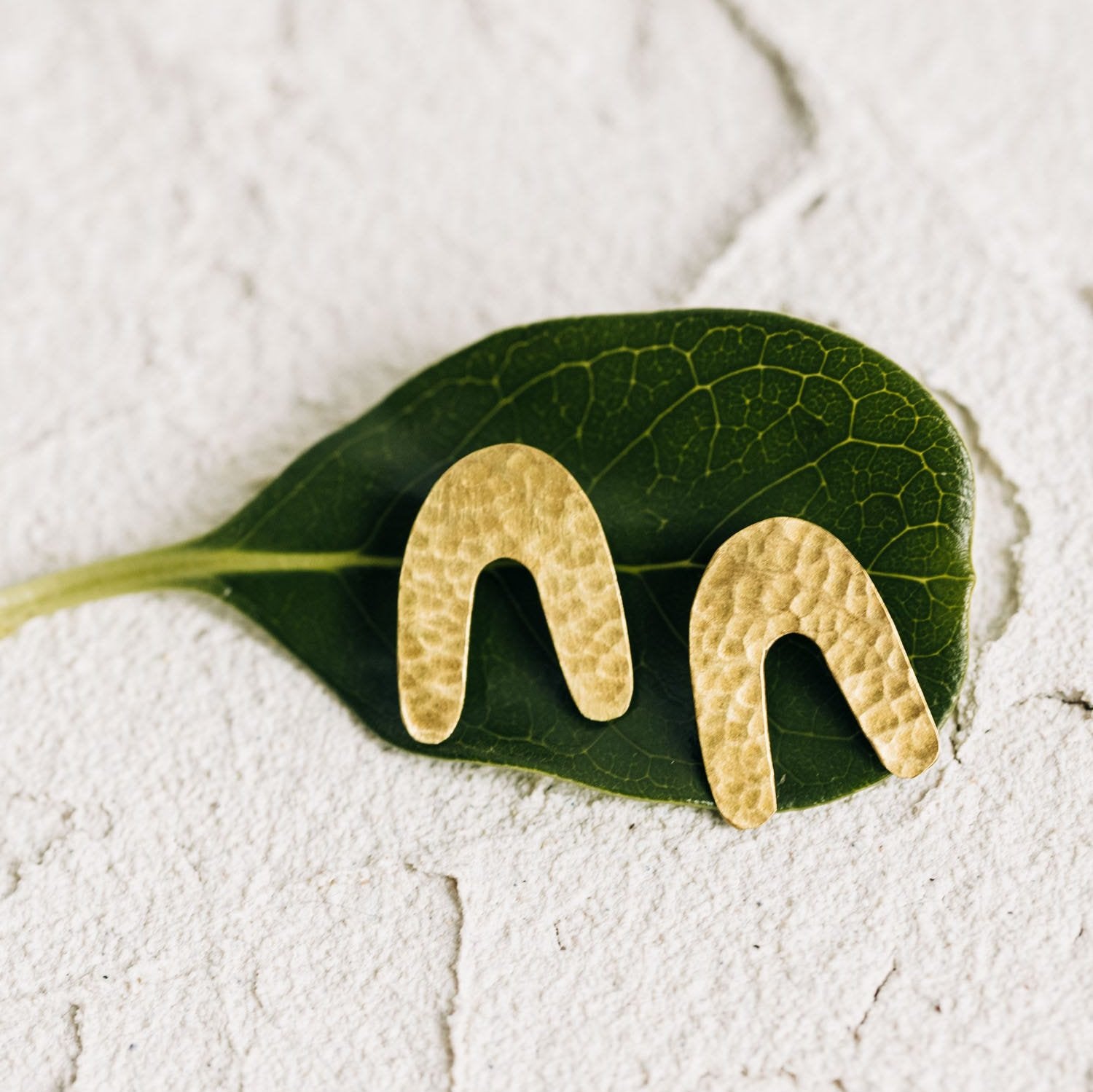 Side view of Boho Archway Brass Earrings highlighting their unique shape.