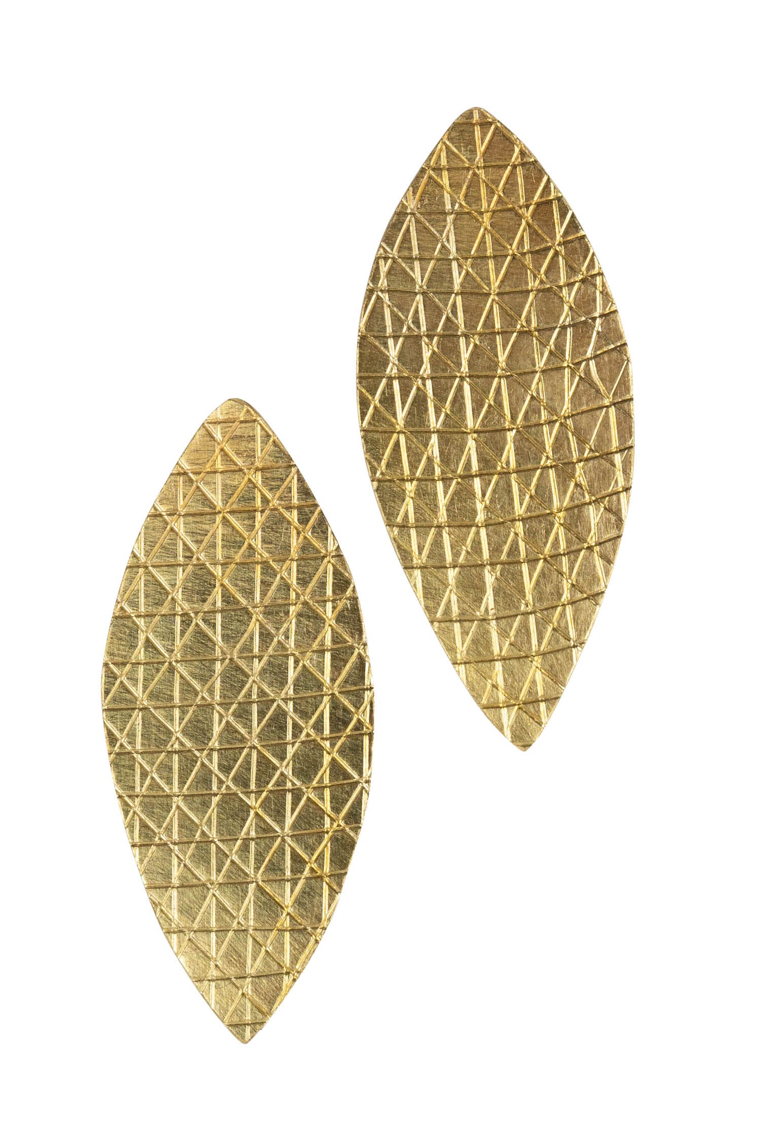 Close-up of handcrafted artisanal earrings with etched patterns showing Kenyan craftsmanship