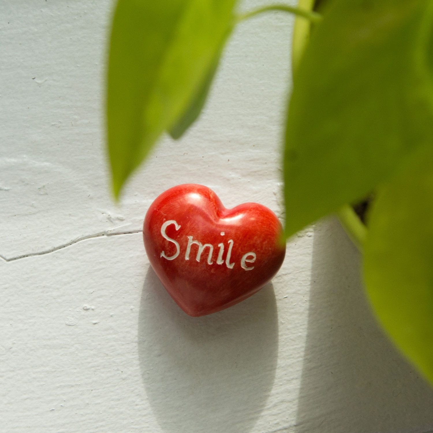Close-up of hand-carved Kisii stone heart paperweight showing fine details