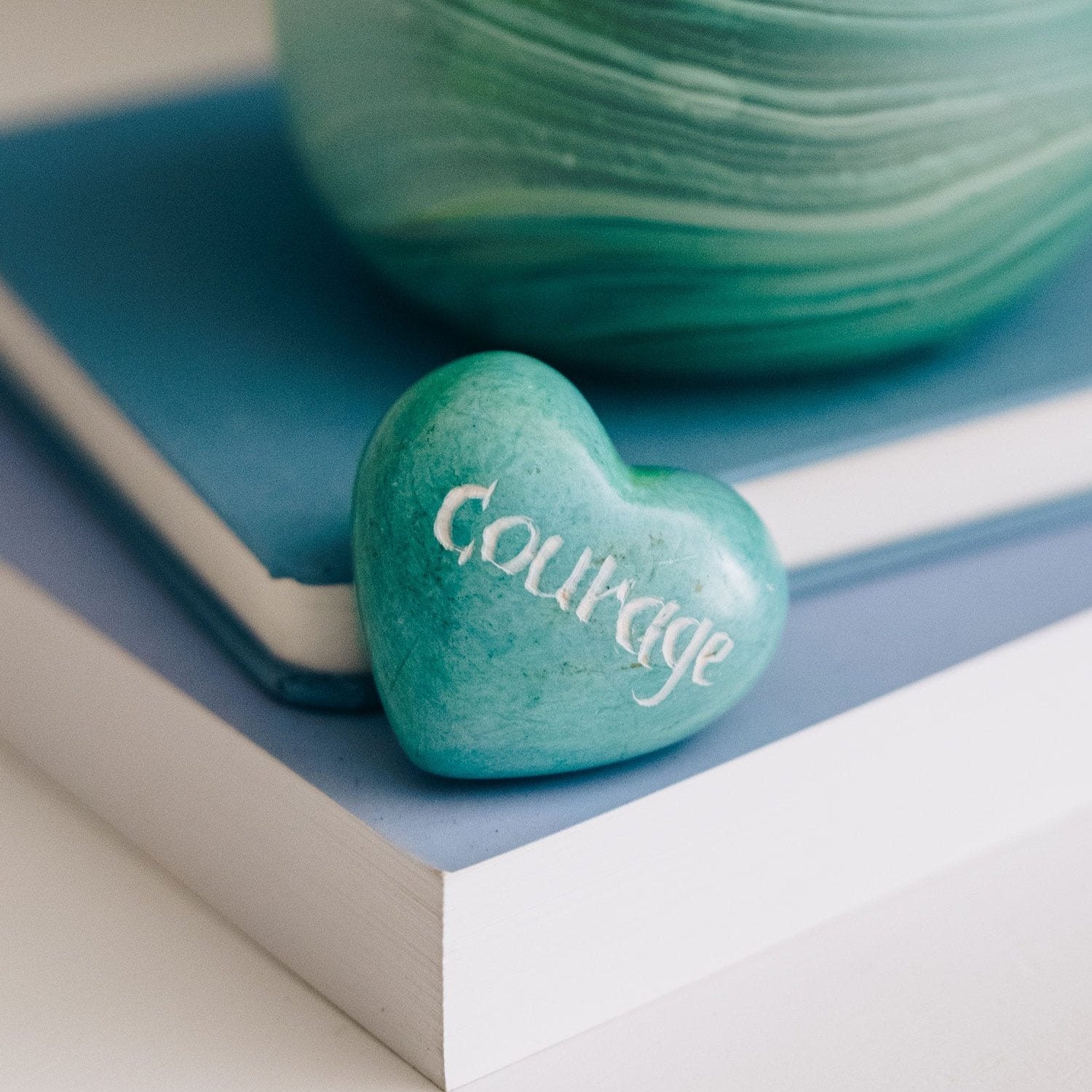 Close-up of the Kisii stone heart paperweight showcasing its smooth finish and intricate carvings.