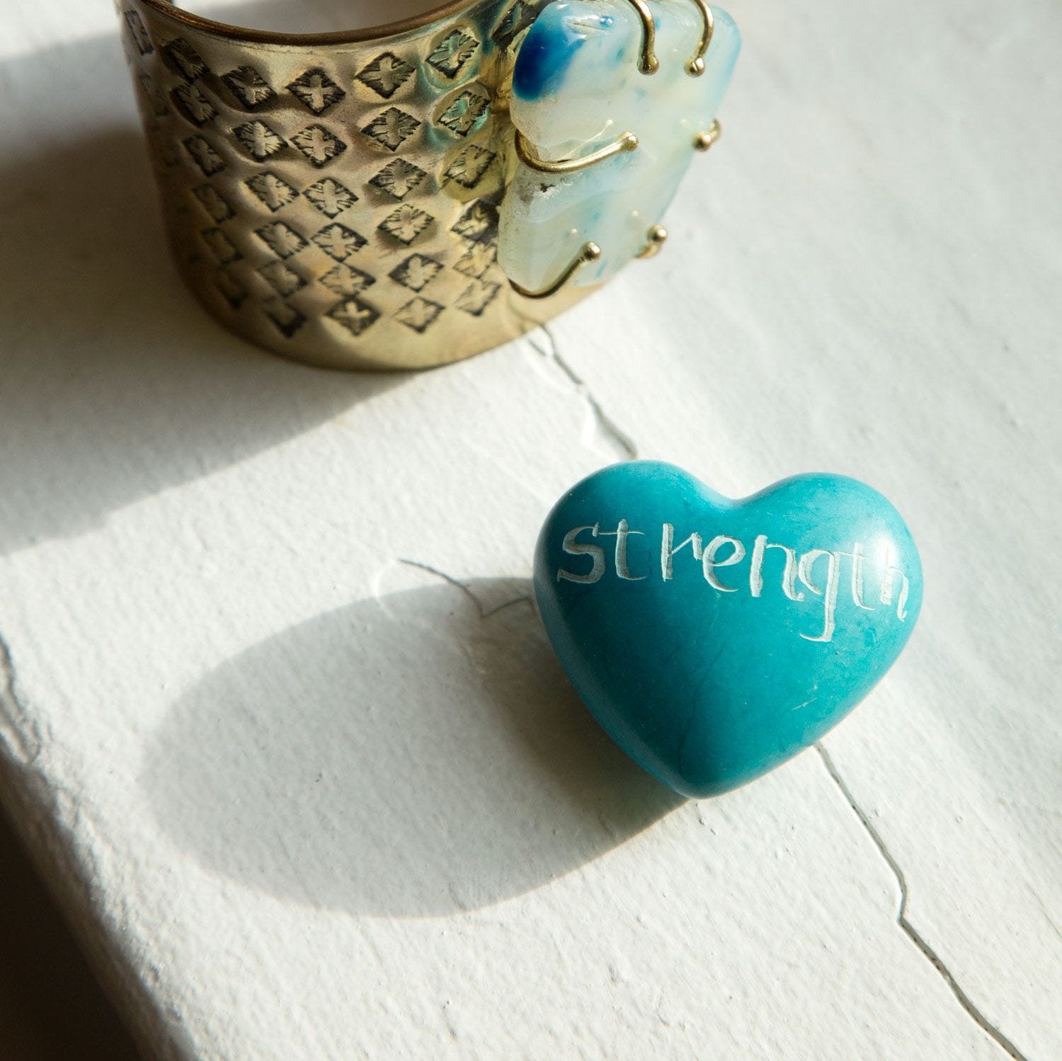 Close-up of hand-carved kisii stone heart paperweight with detailed carving and smooth finish