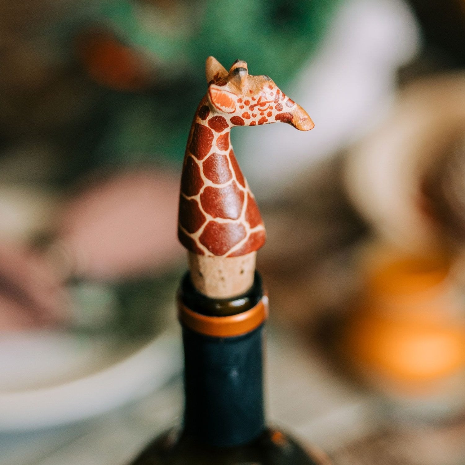 Close-up of a handcrafted giraffe wooden wine cork on a bottle