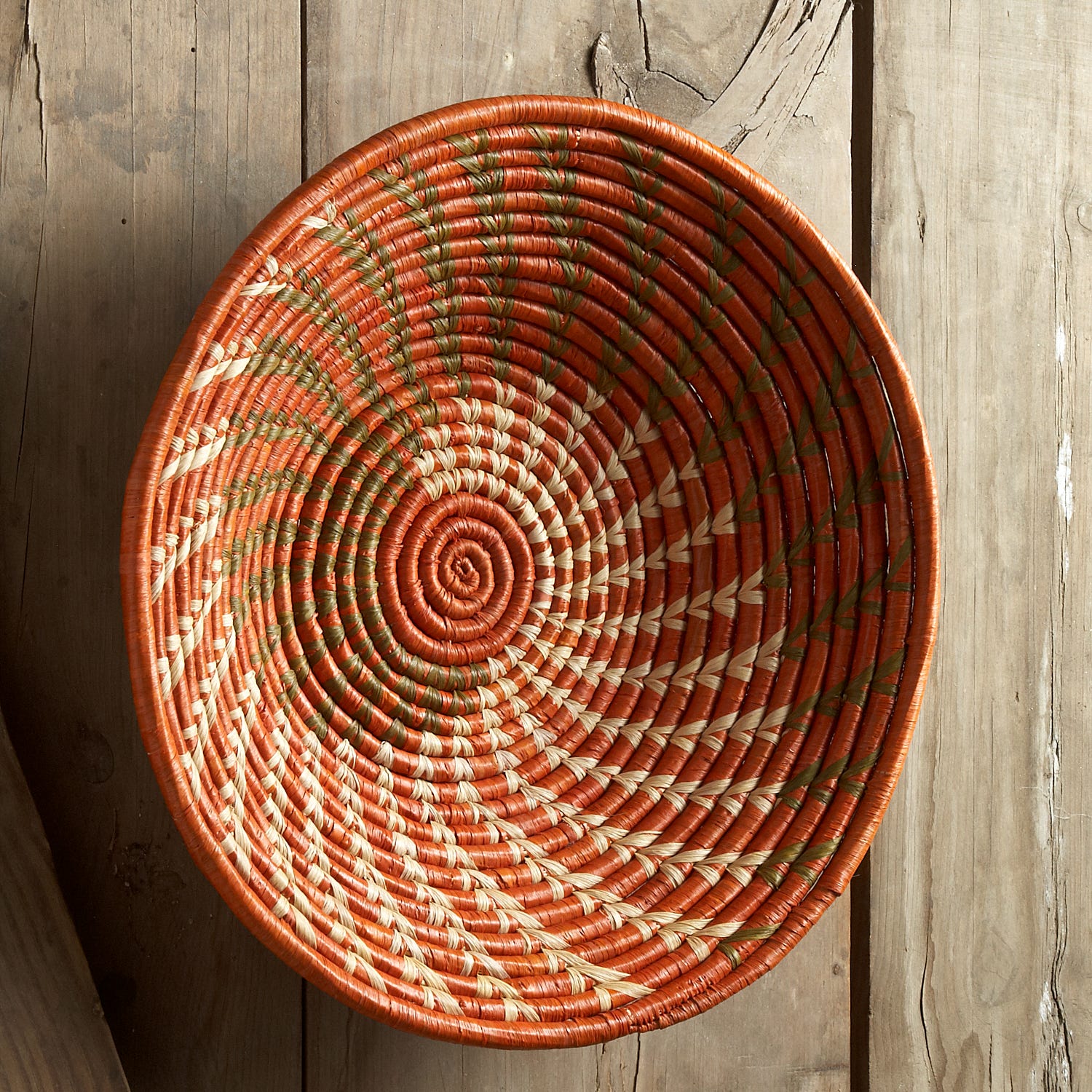 Close-up of vibrant woven natural fiber basket showing detailed craftsmanship