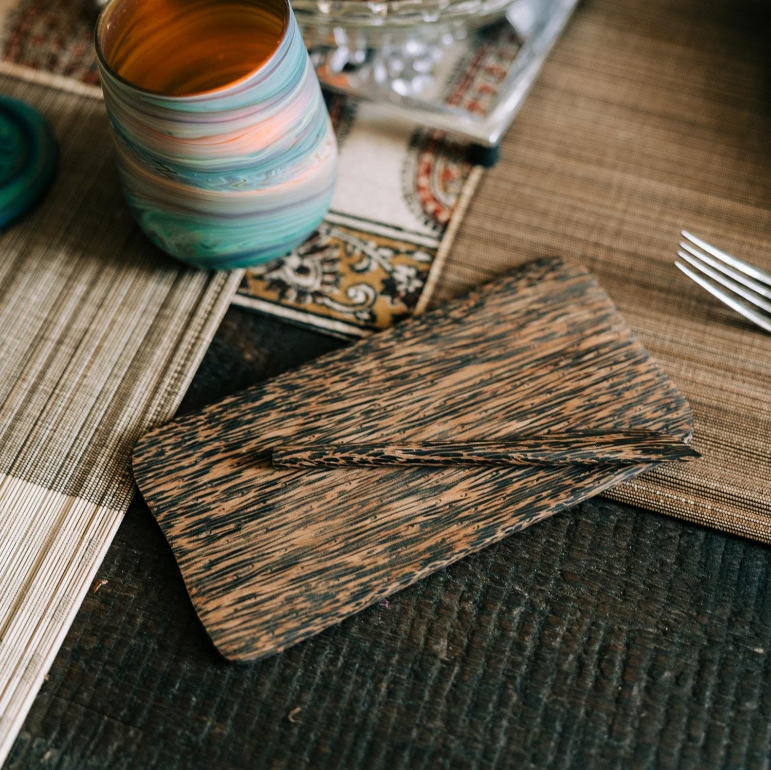 Overhead shot of palm wood butter board with chive butter and baguette slices