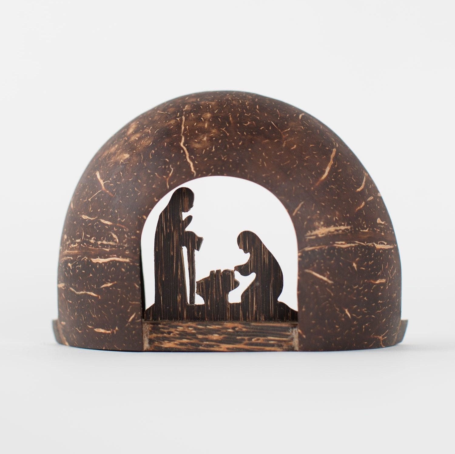 Handcrafted coconut shell nativity set displayed in a cozy living room, showcasing its rustic charm.