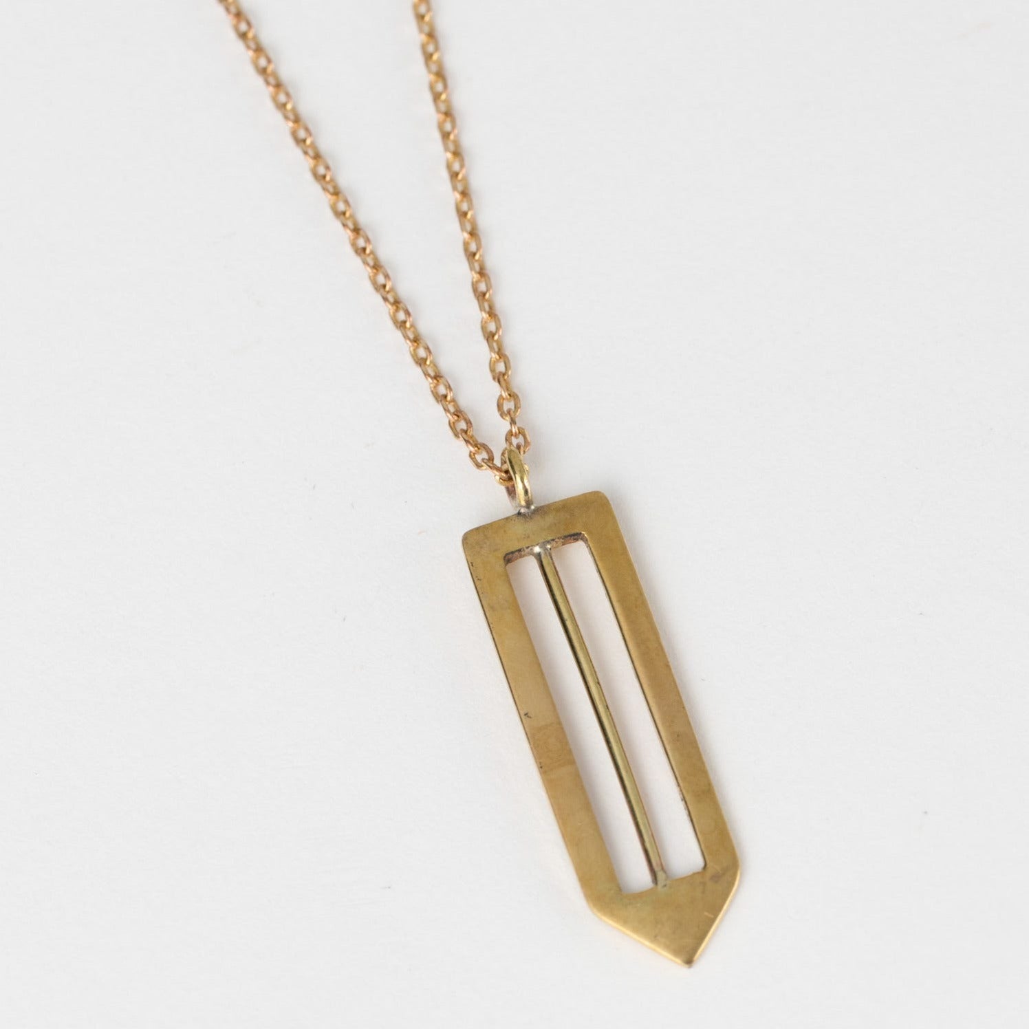 Close-up of the handcrafted arrow necklace showing detailed artisan craftsmanship