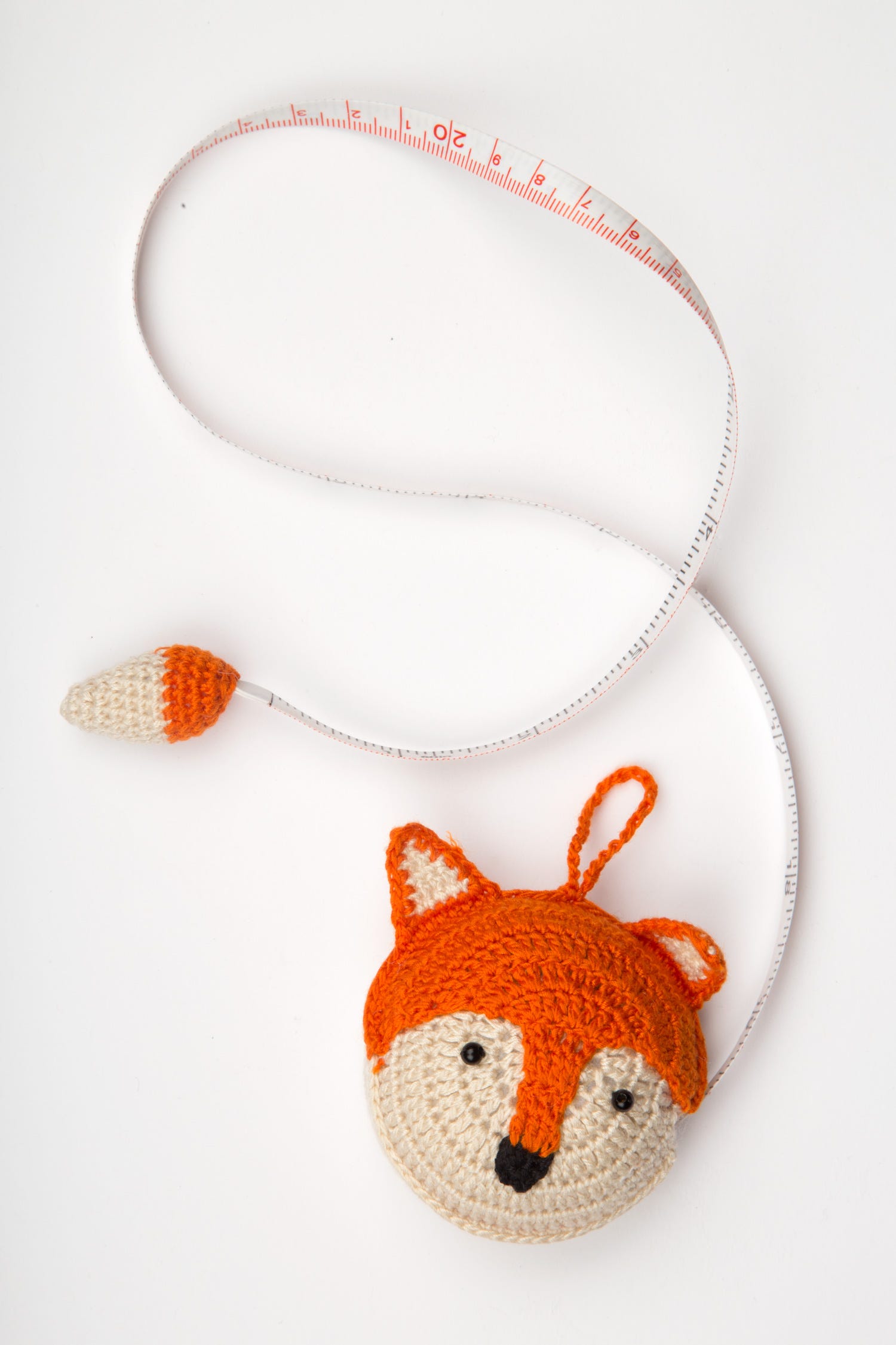 Close-up of the Charming Artisan Fox Measuring Tape showcasing its hand-crocheted cotton cover.