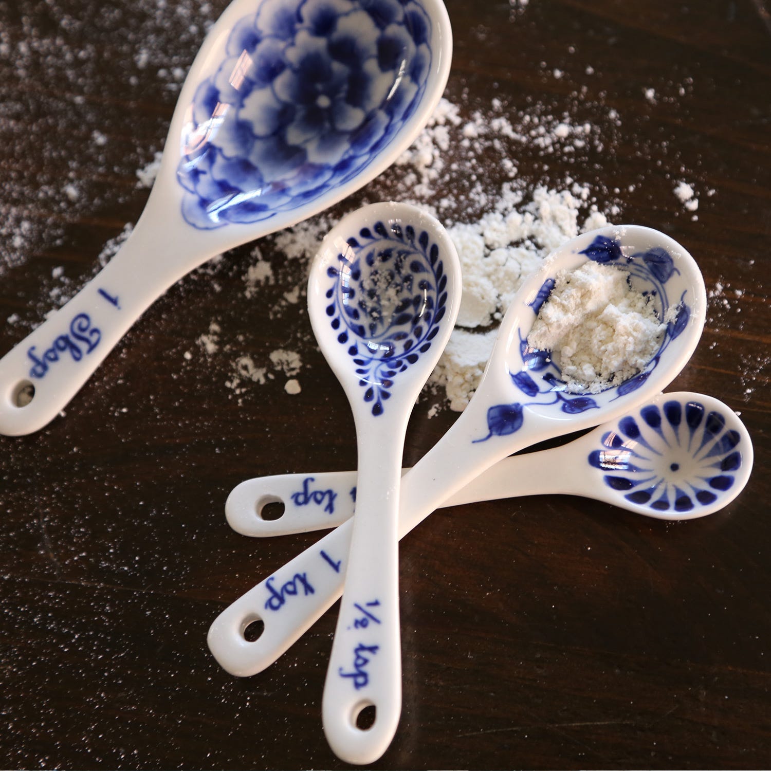 Close-up of hand-painted ceramic measuring spoons in a kitchen setting