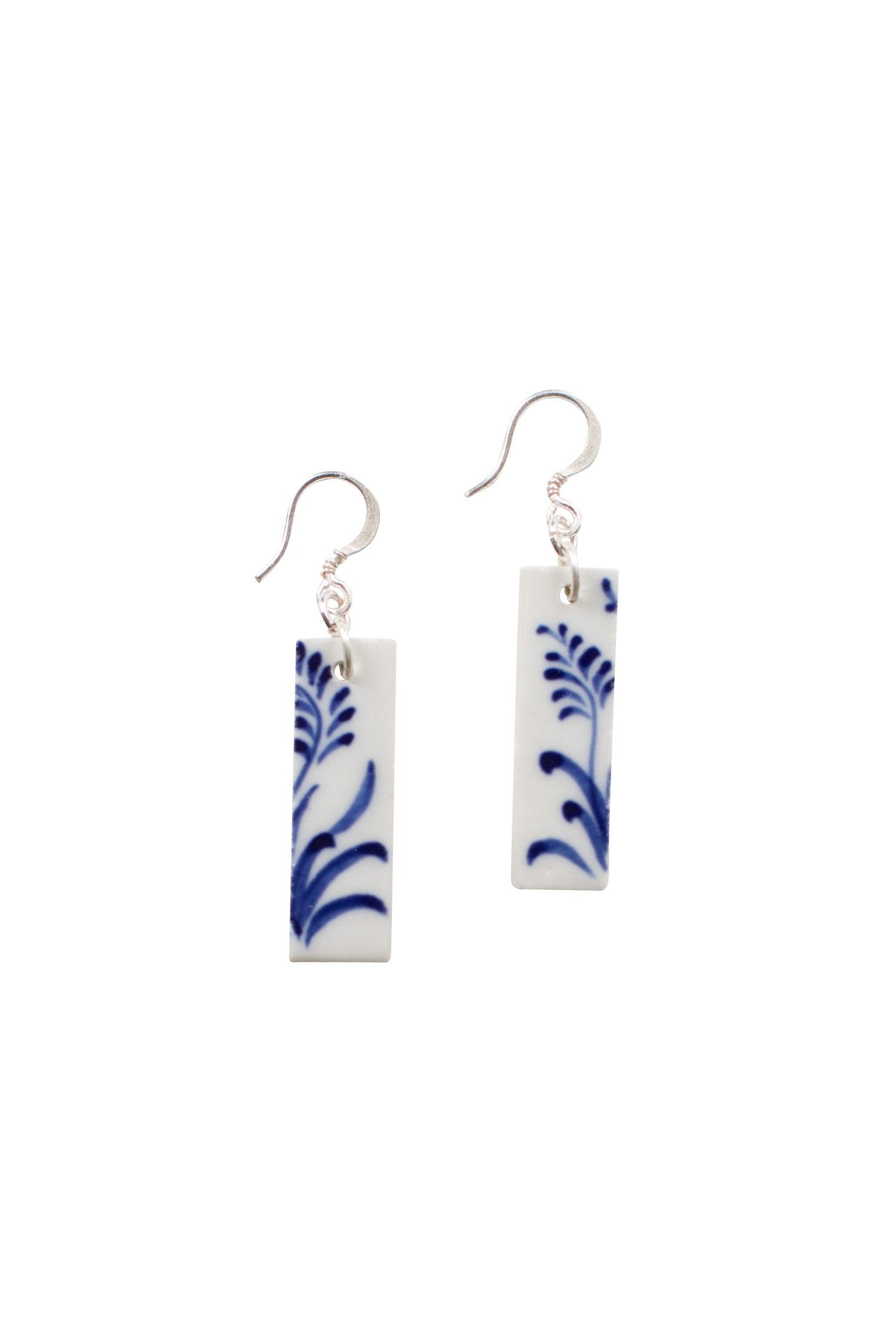 Close-up of hand-painted ceramic earrings from Bat Trang, highlighting intricate designs.
