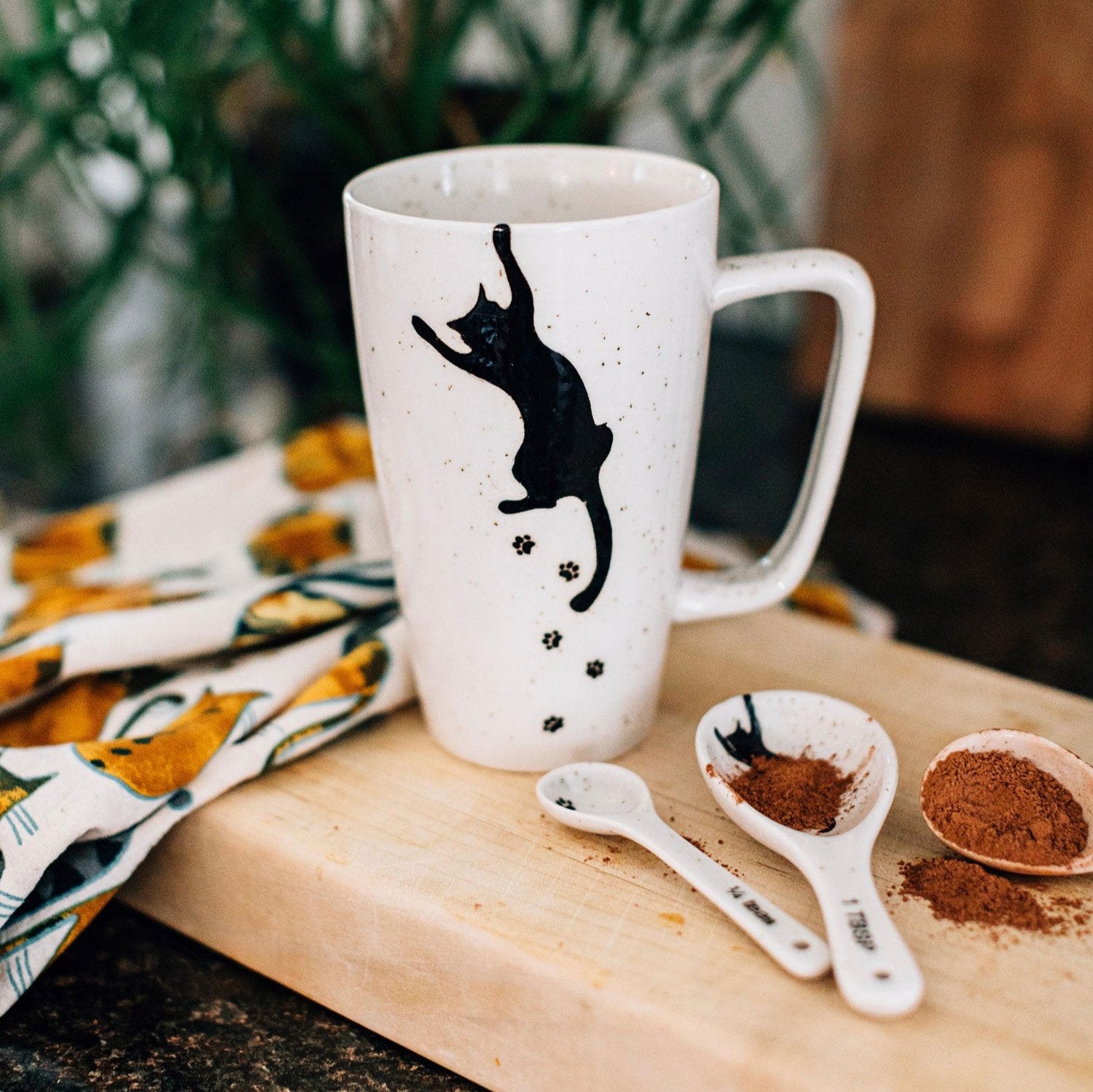 Curious cat coffee mug showcasing hand-painted details from Bat Trang, Vietnam.