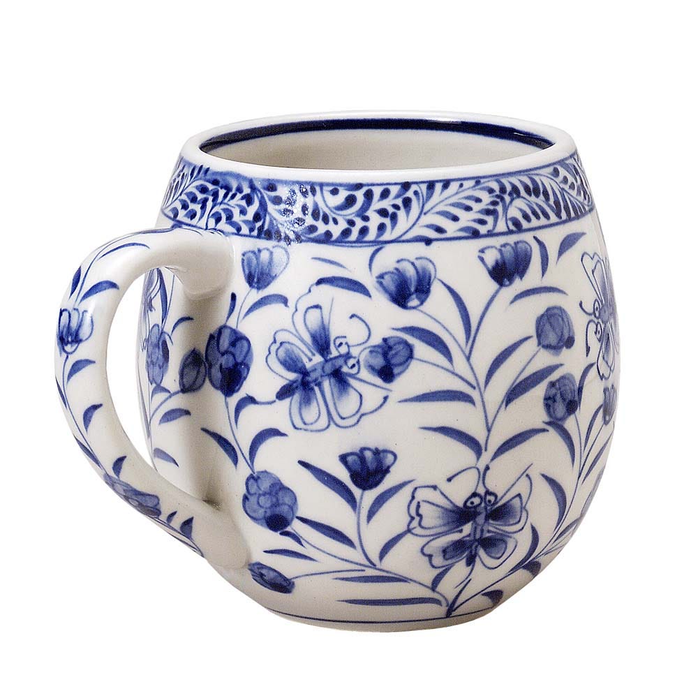 Close-up of blue artisan handpainted ceramic mug showing detailed blue motifs