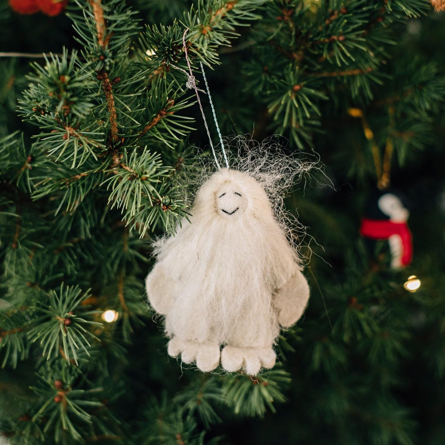 Close-up of the handcrafted yeti ornament showcasing intricate felt details.