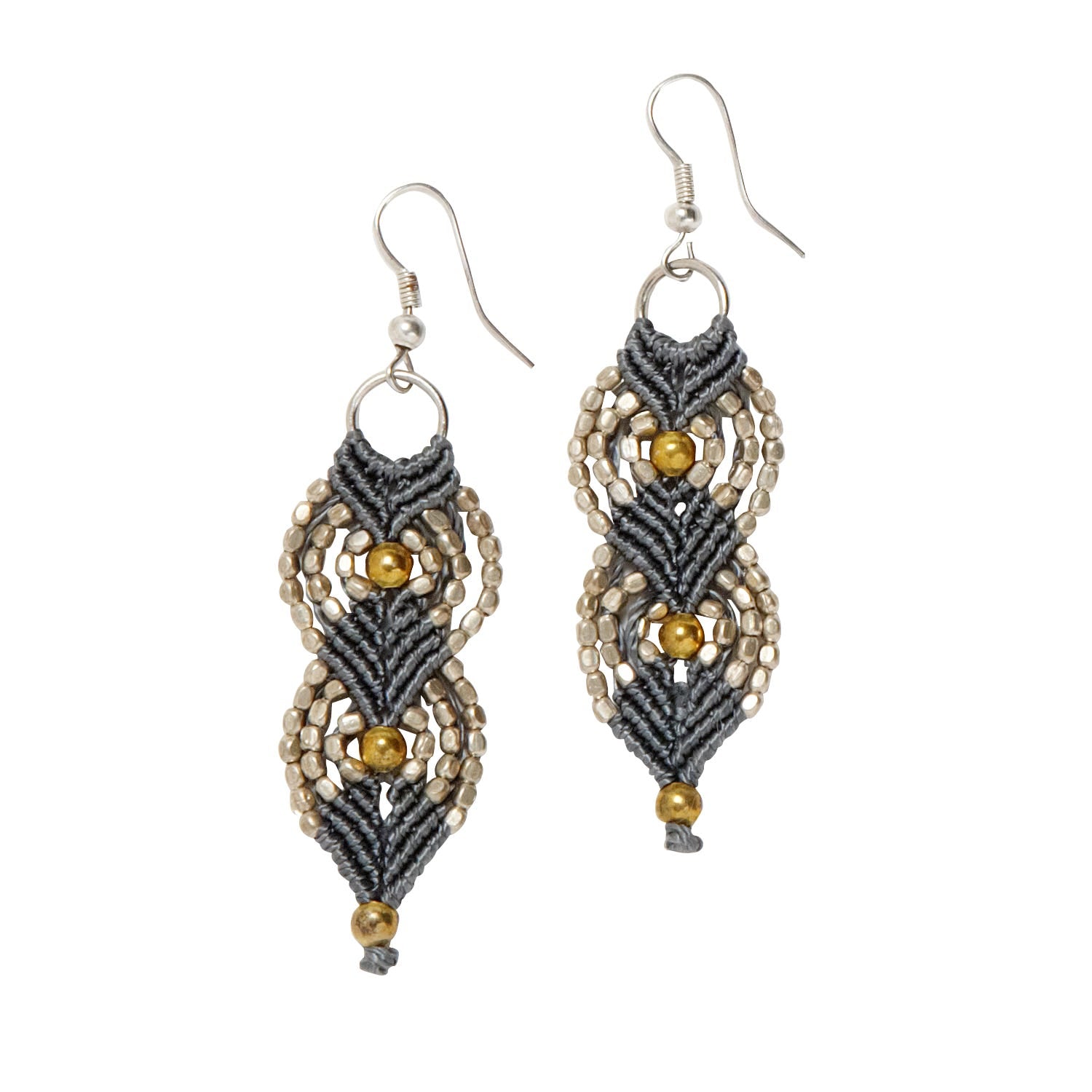 Detailed view of bohemian earrings with metallic beads and macramé design