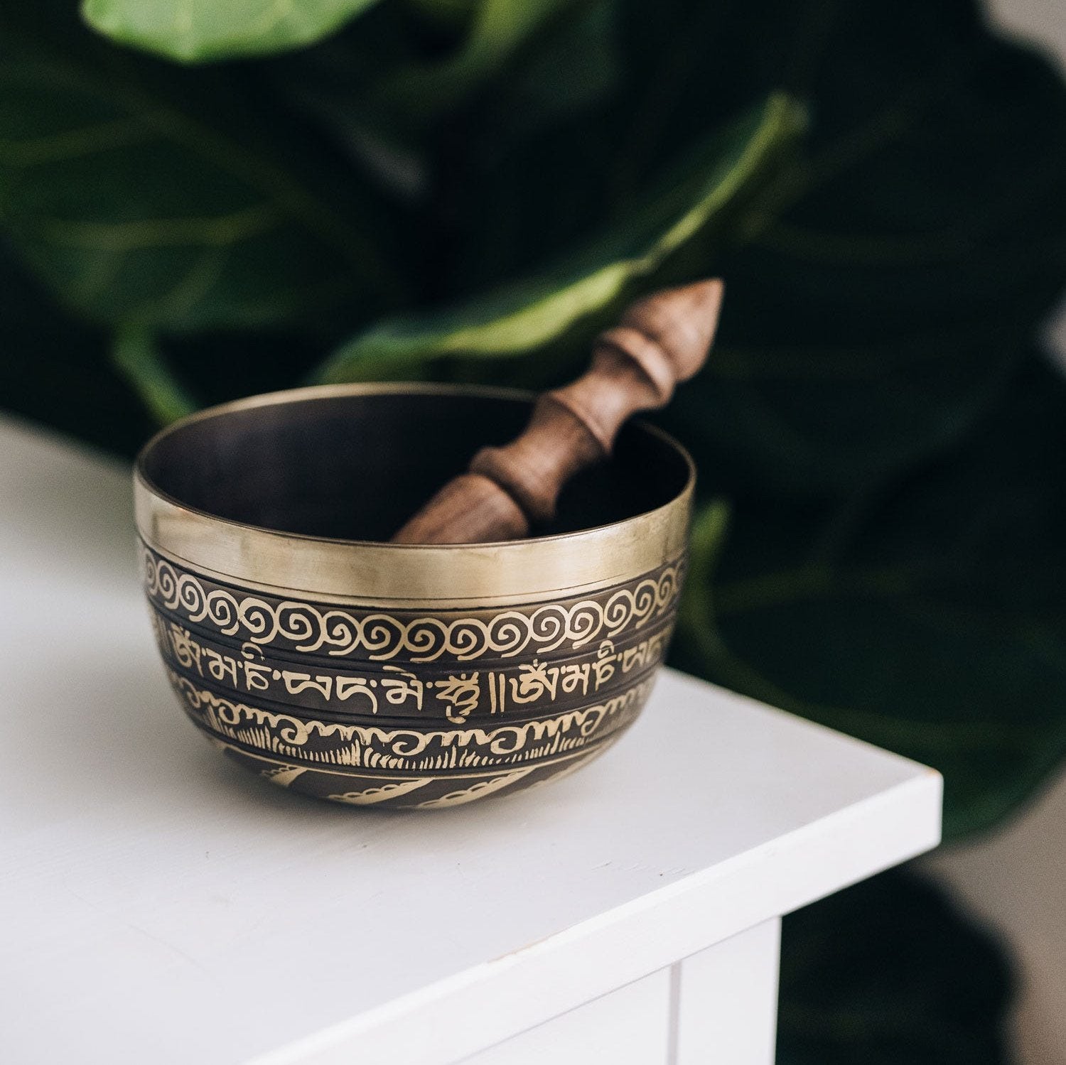 Bajra singing bowl with intricate Tibetan inscriptions, perfect for meditation.