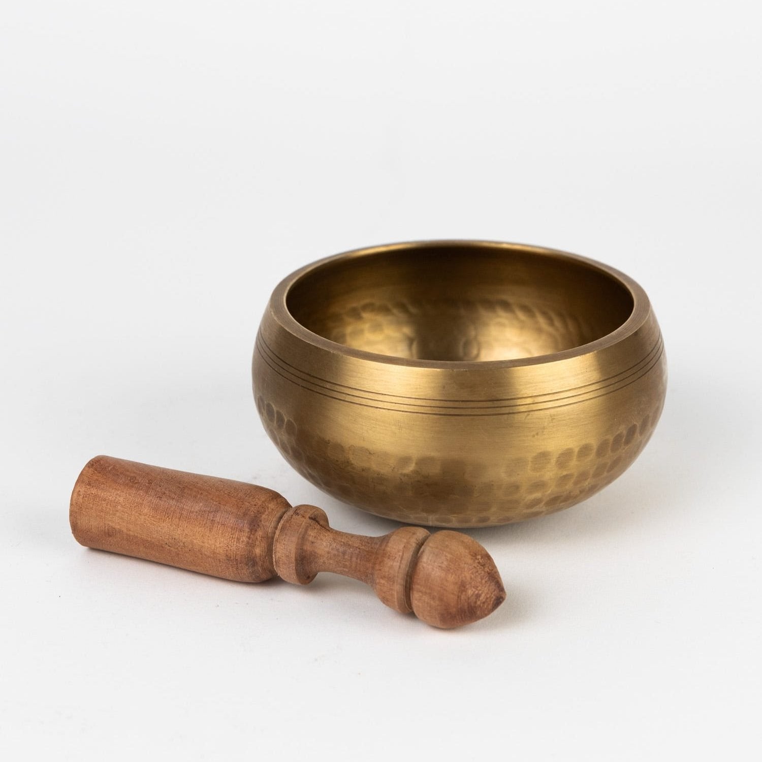 Close-up of Kathmandu singing bowl showing intricate craftsmanship and cushion.