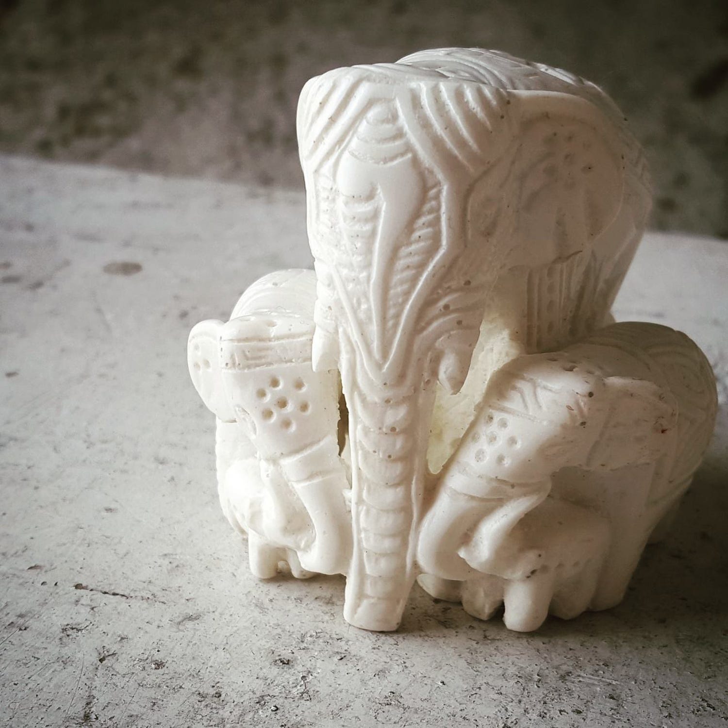 Charming Elephant Family Figurine viewed from the front, showcasing intricate engravings.