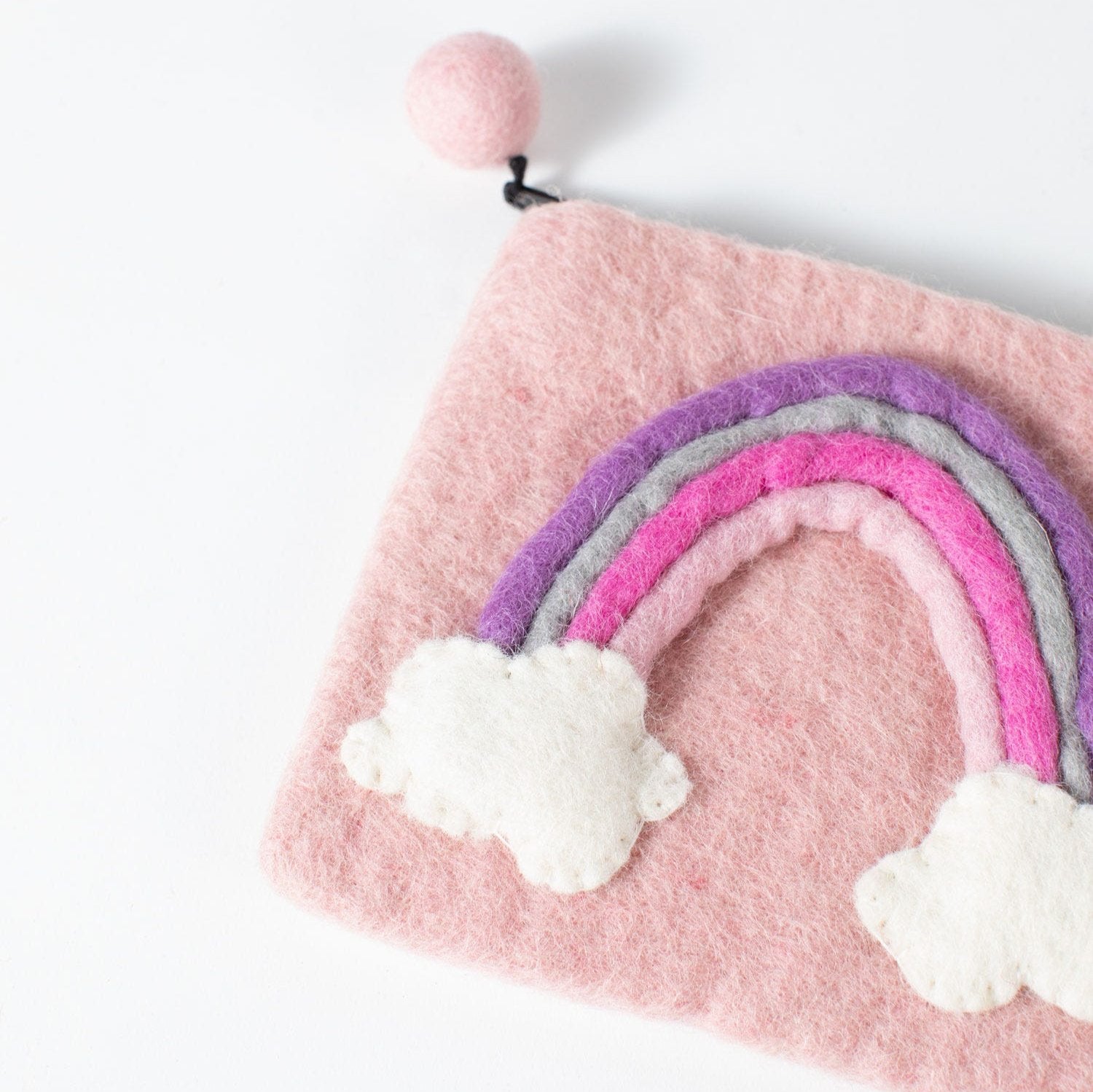 Vibrant rainbow felt coin purse open, showcasing interior design.