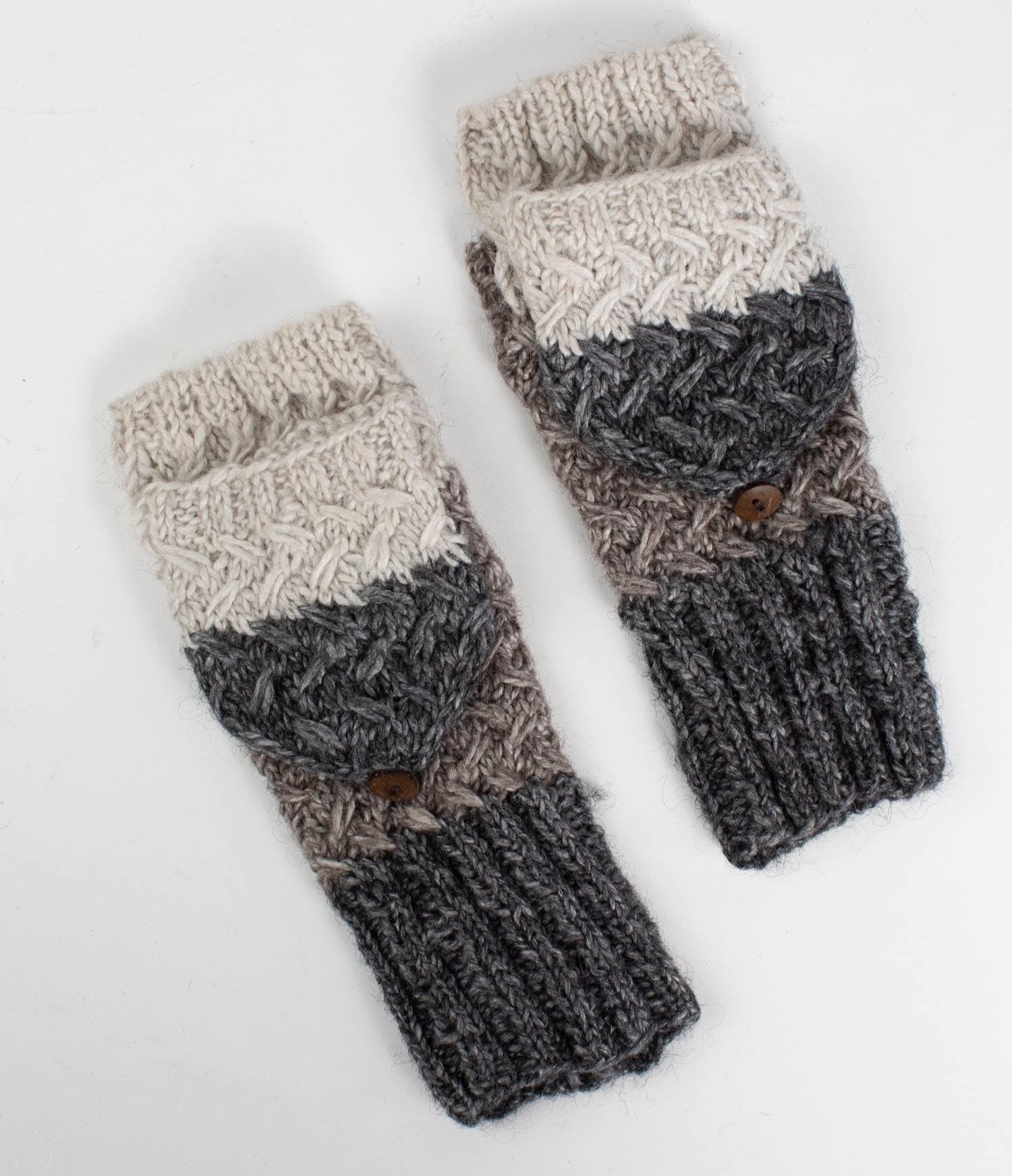 Cozy wool convertible mittens displayed on a snowy backdrop, showcasing their hand-knit design.