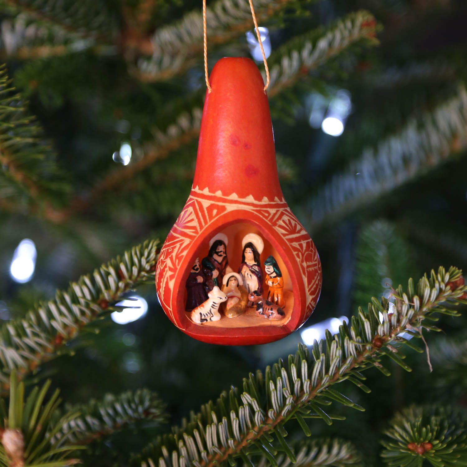 Vibrant gourd nativity ornament showcasing retablo art from Peru.