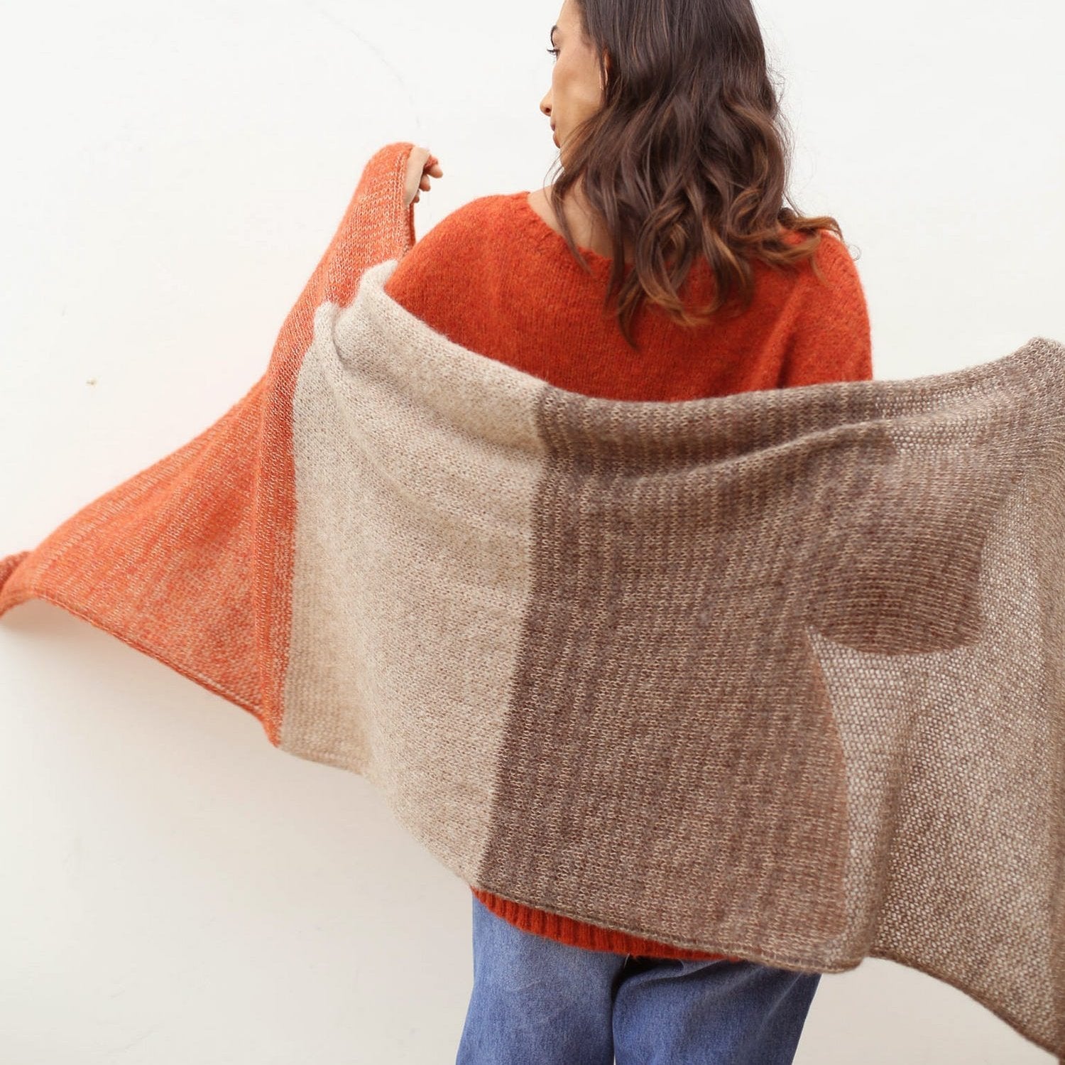 Close-up of earthy tones in a handmade alpaca shawl, highlighting the soft fibers and craftsmanship