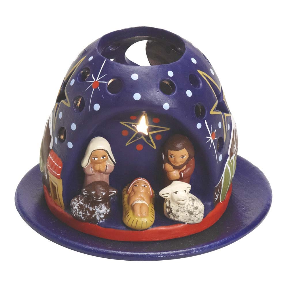 Close-up of the mountain tea light nativity with star cut-outs illuminated at night