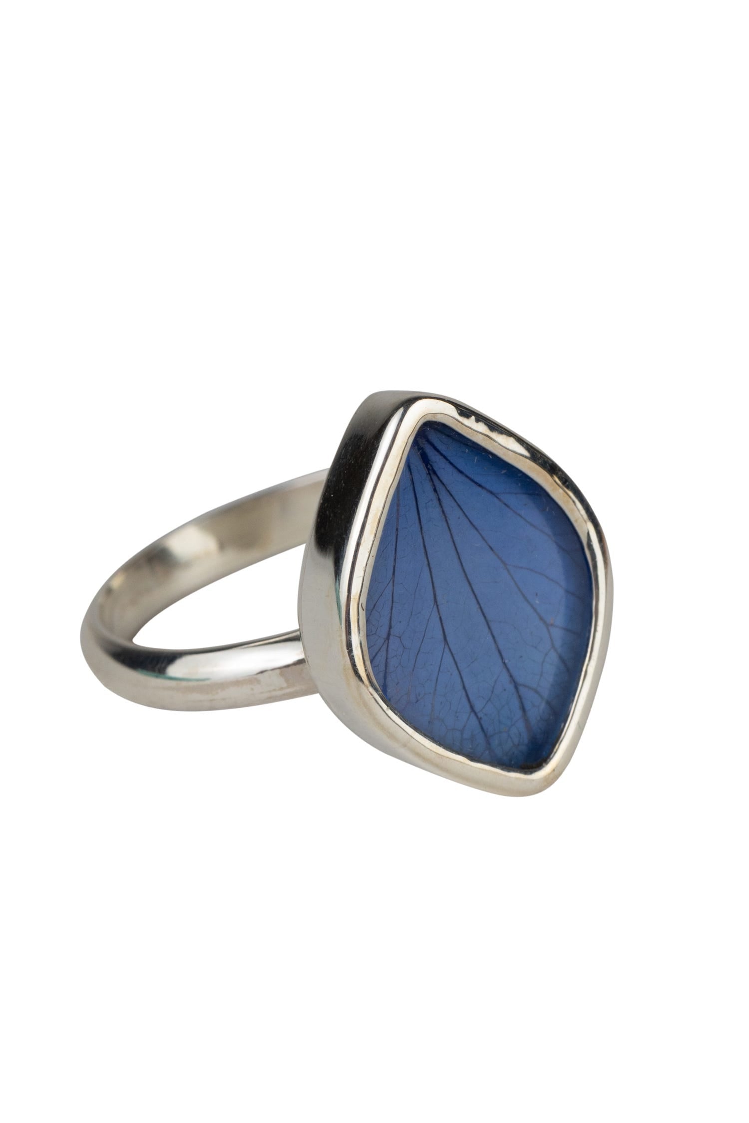 Close-up of Nature's Embrace Deep Blue Flower Ring highlighting the intricate details of the flower petal encased in glass.
