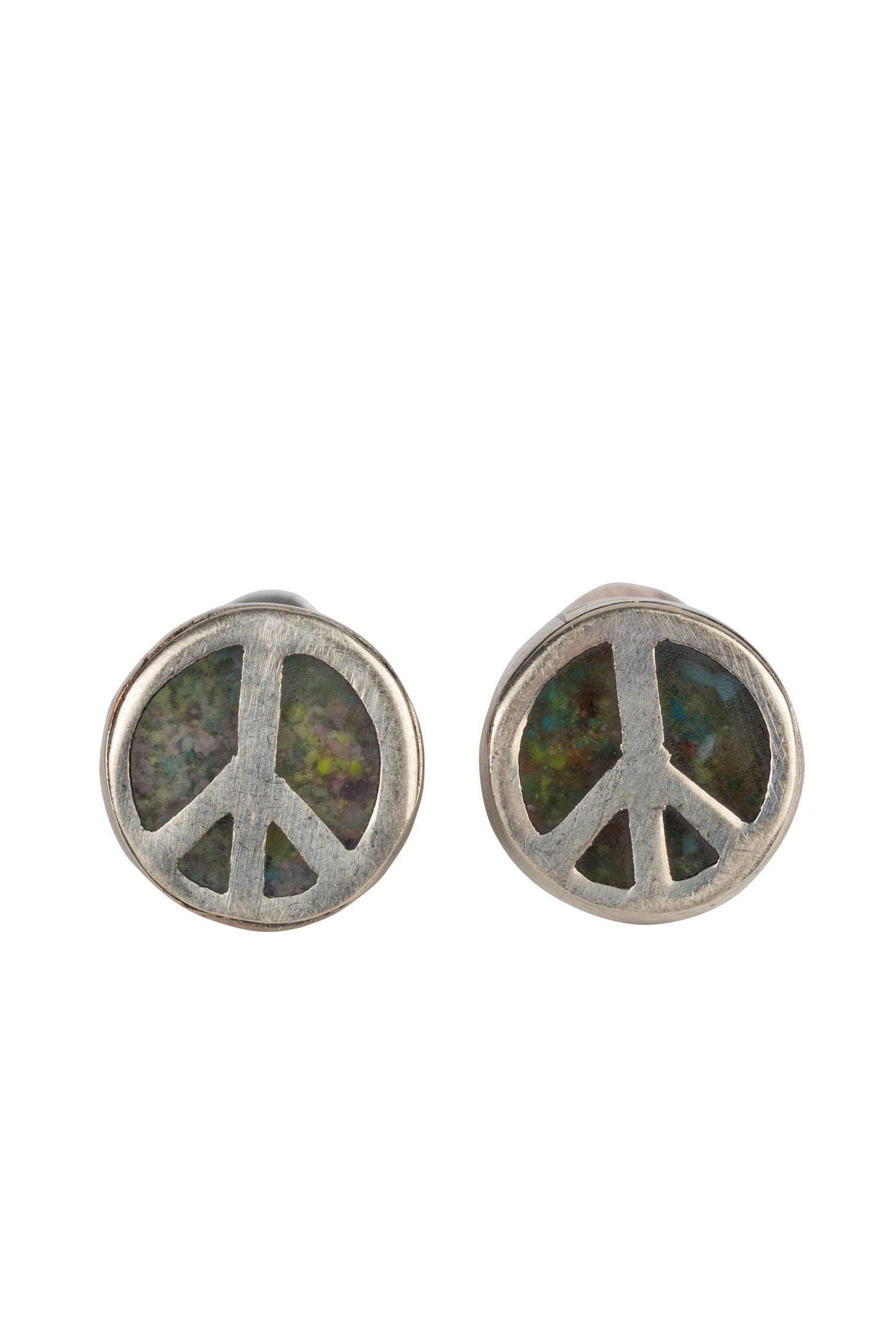 Side view of charming silver peace sign stud earrings on a display.
