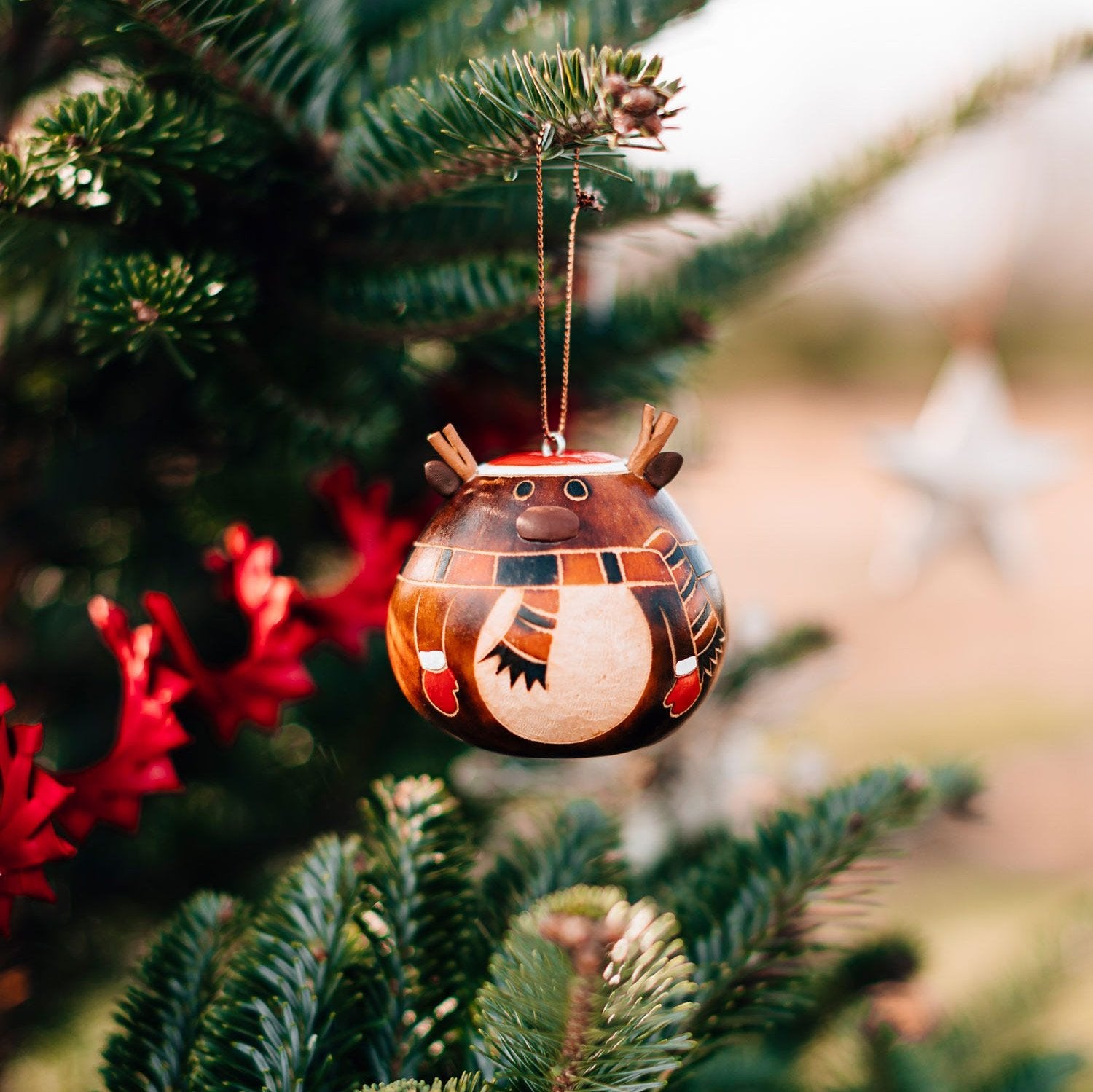 Close-up of the festive gourd hat ornament highlighting its vibrant colors and craftsmanship.