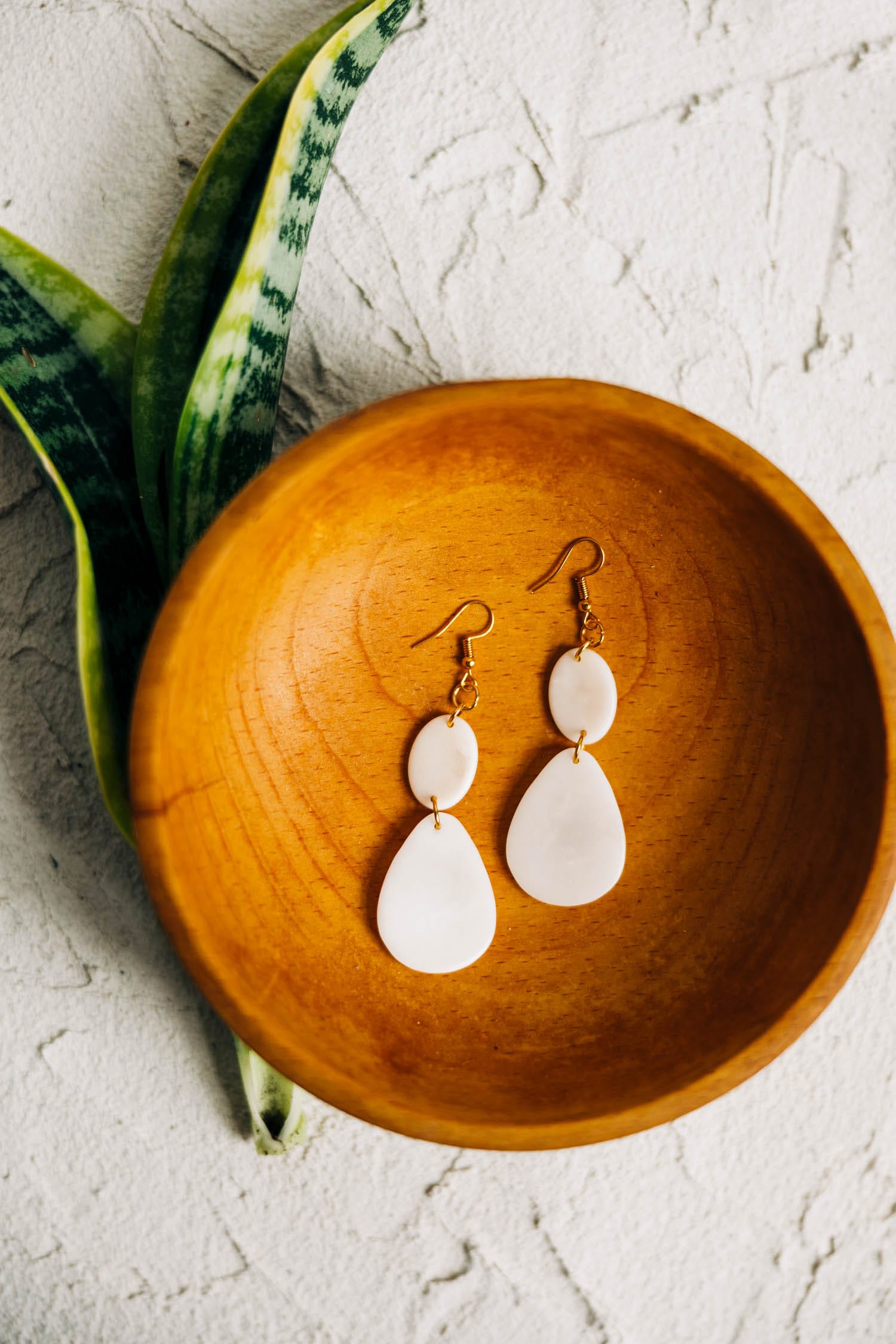 Close-up of lightweight vegan ivory earrings on a white background, highlighting craftsmanship