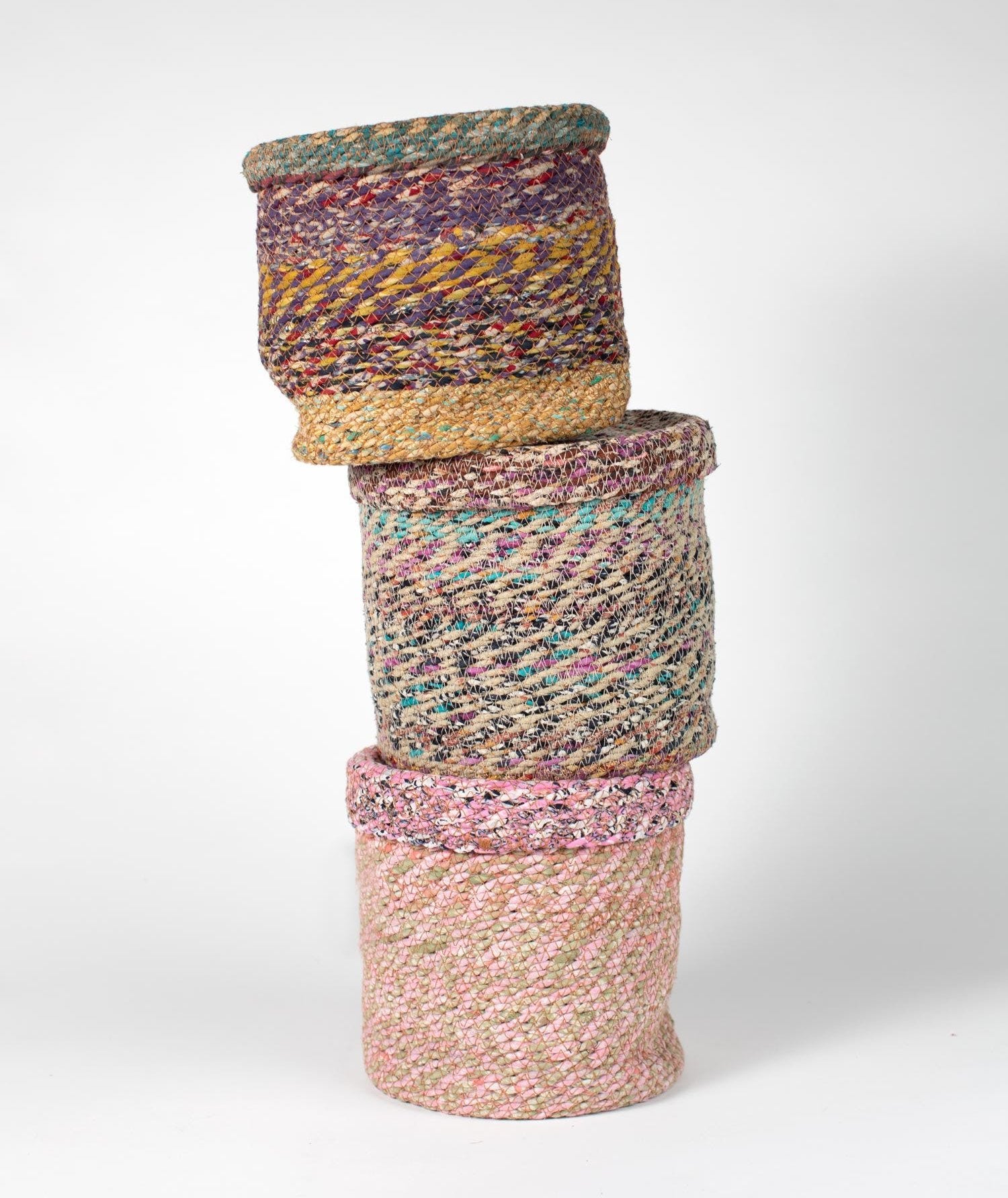 Vibrant handcrafted sari lidded basket in a living room, showcasing its colorful design and practical use for storage.