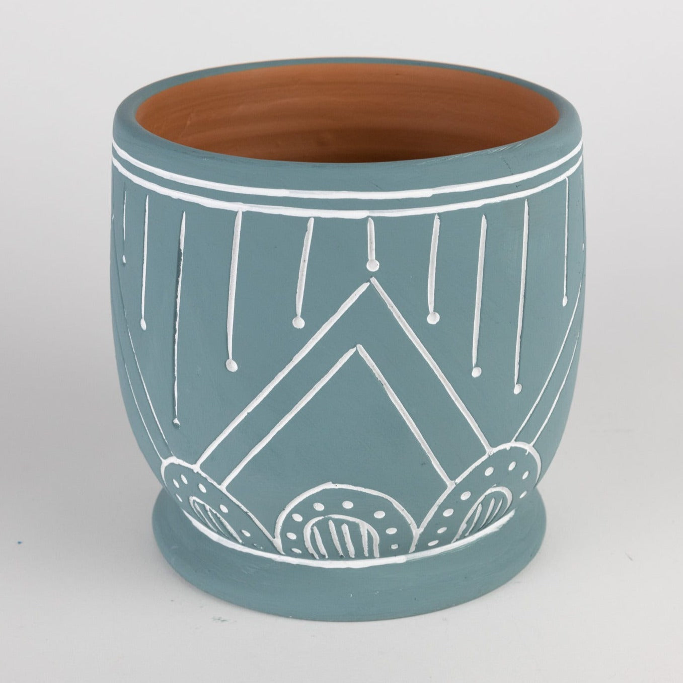 Geo teal terracotta planter showcasing its unique geometric patterns from a side angle.
