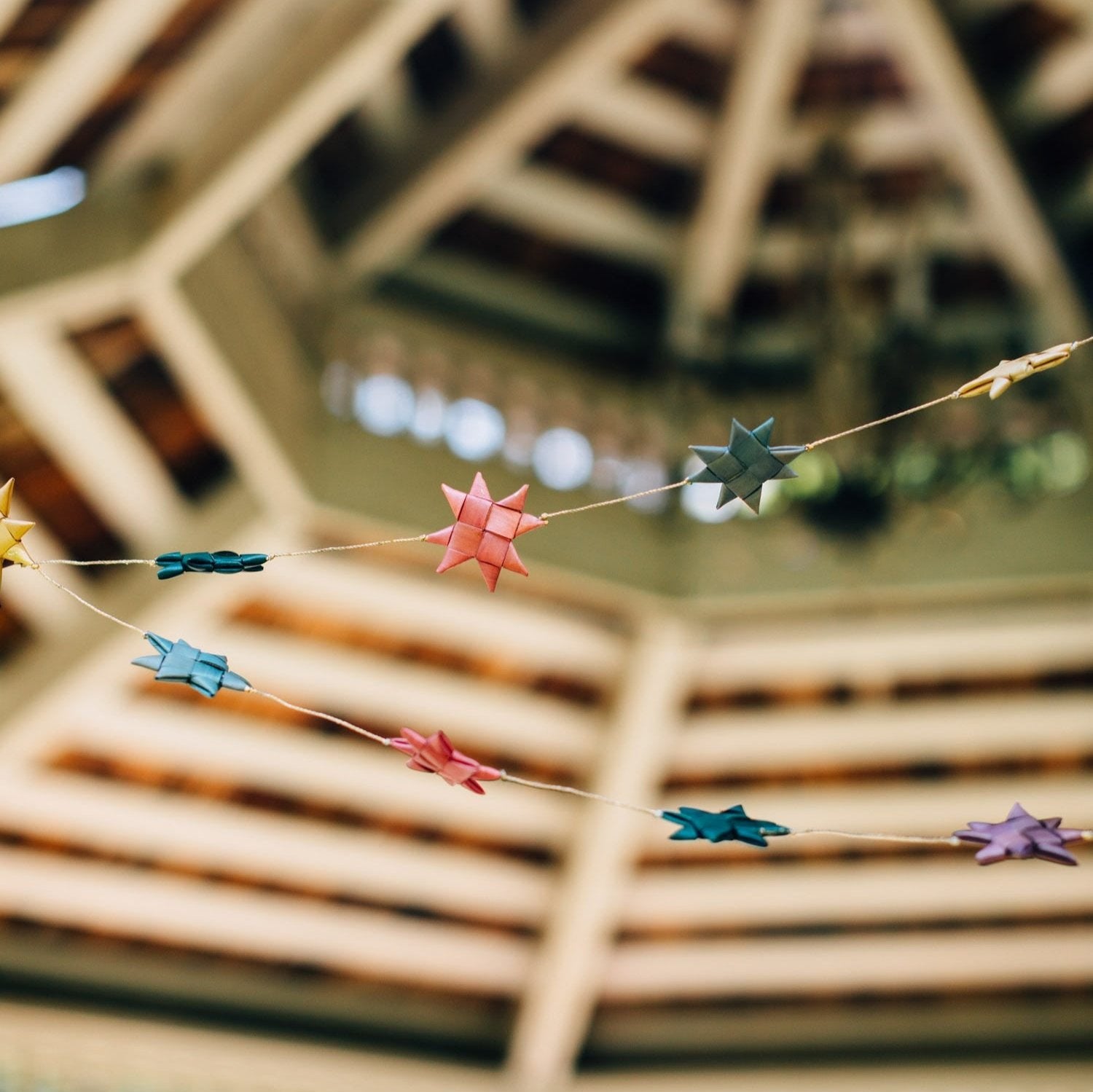 Radiant multicolor star string lights elegantly displayed in a cozy bedroom.