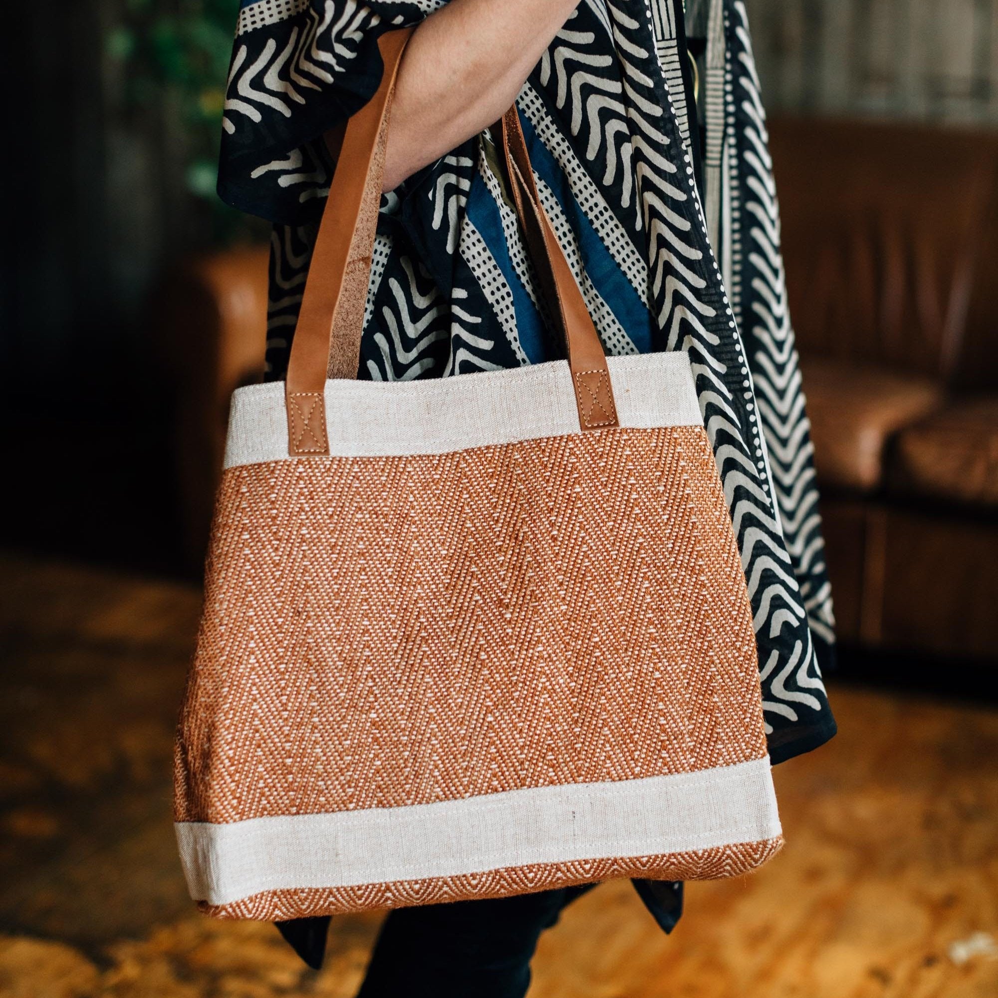 Artisan crafted jute and cotton shoulder bag with leather straps, showcasing its durable construction and elegant design.
