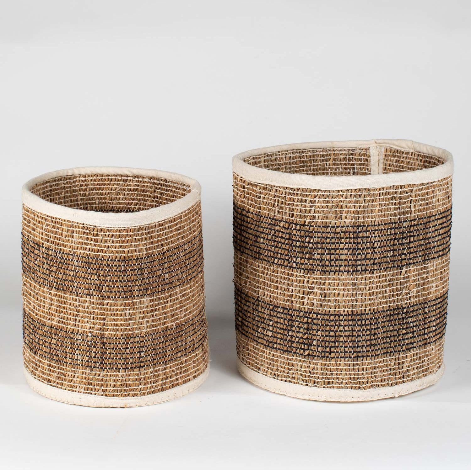 Close-up of handcrafted hogla woven basket showcasing black and white stitching