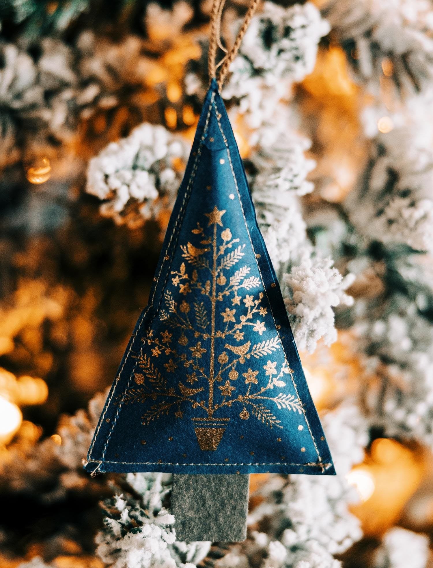 Close-up of a metallic gold Christmas tree ornament with intricate design