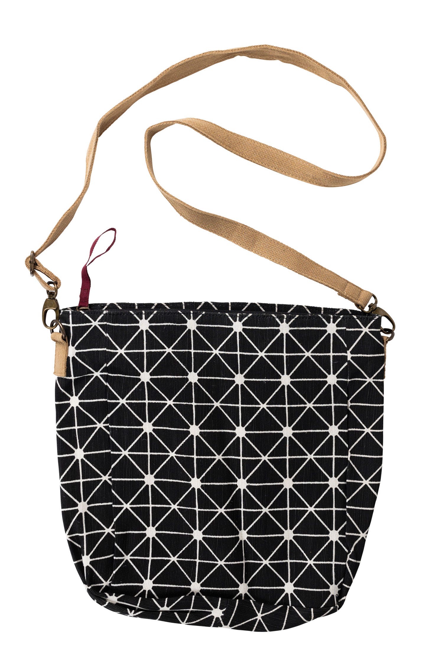 Front view of black canvas crossbody bag with white geometric print and adjustable tan strap