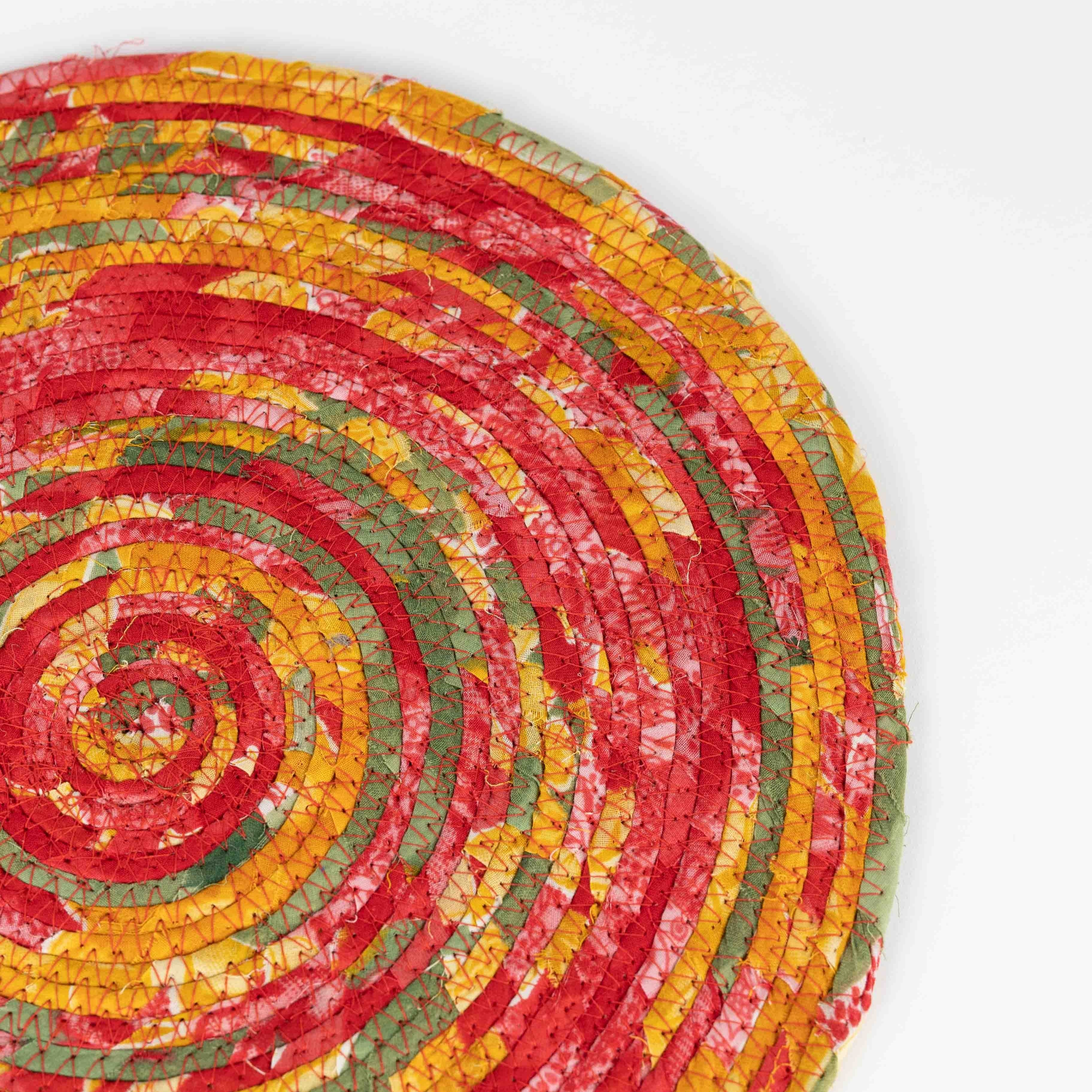 Close-up of the vibrant colors in the unique sari fabric placemat.