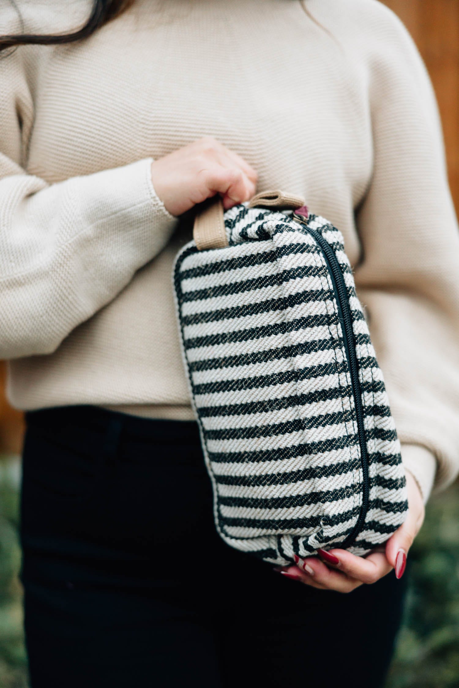 Overhead view of the handmade travel bag showing zippered closure and cotton texture