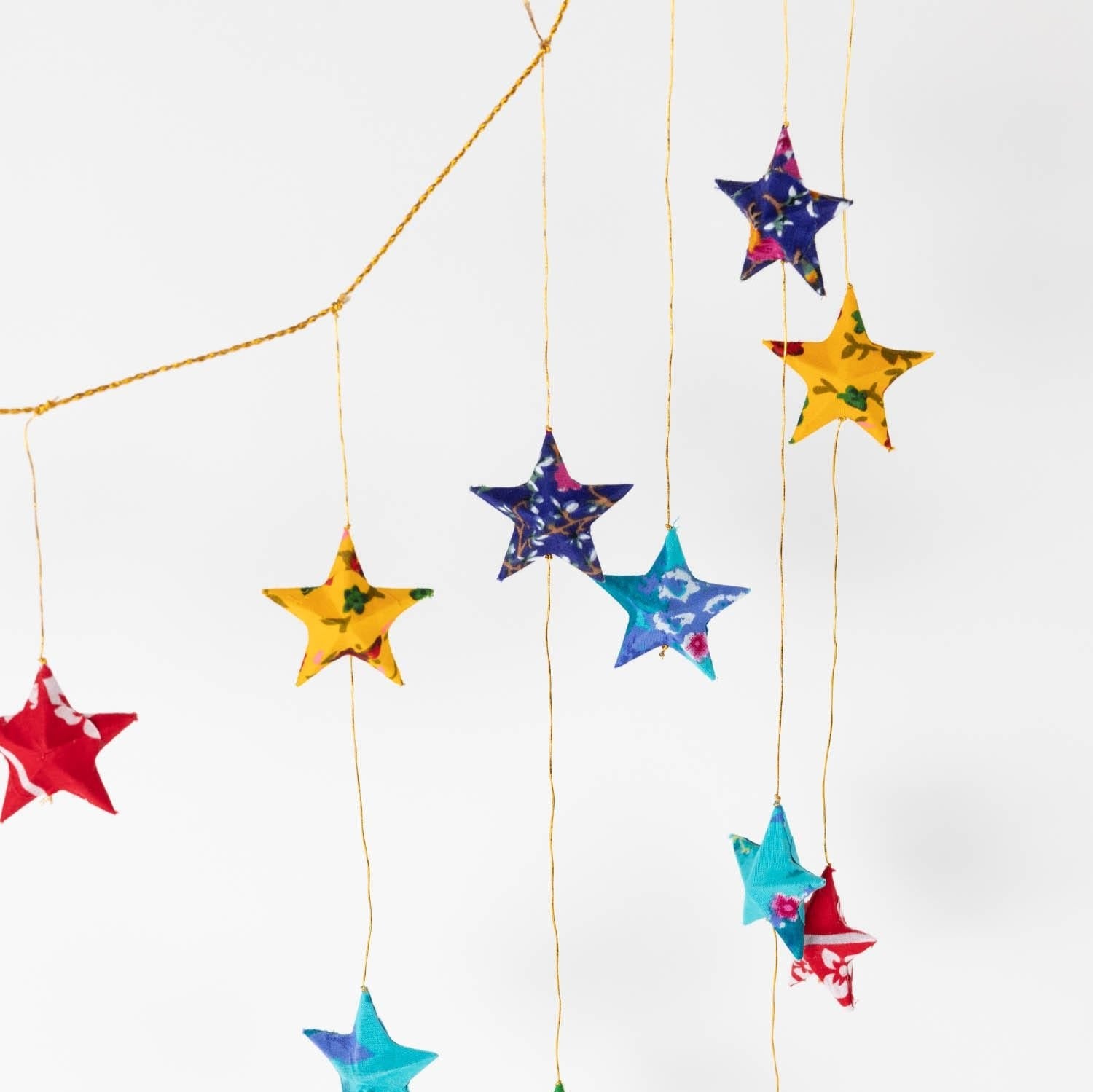Close-up of star-studded upcycled sari fabric valance for eco-friendly window decor