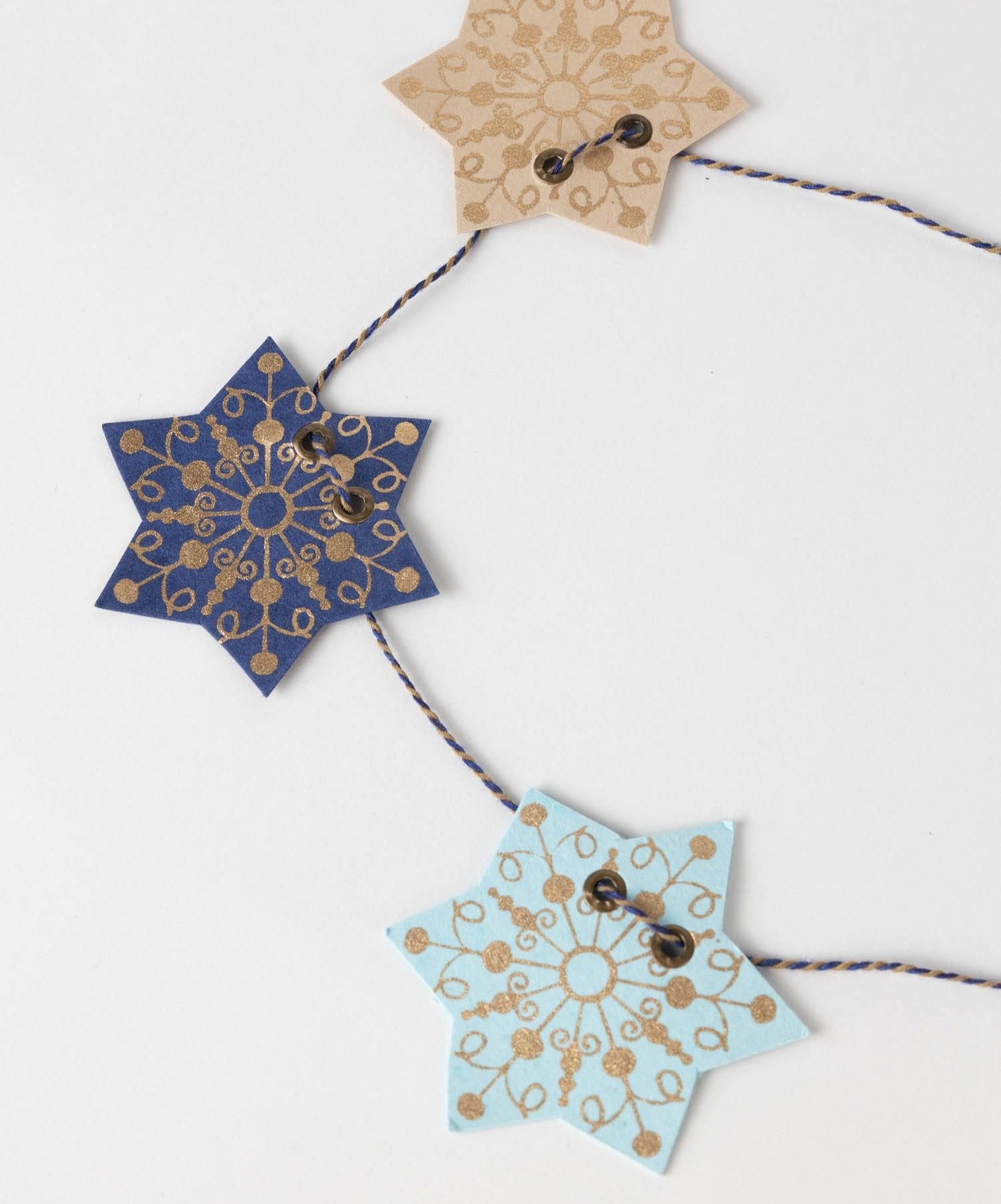 Star garland draped across a fireplace mantle with soft lighting – perfect star decoration for cozy evenings.