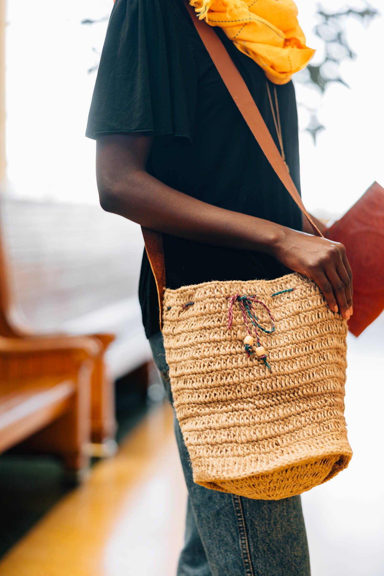 Eco-friendly jute bucket bag with leather strap, perfect for daily use.
