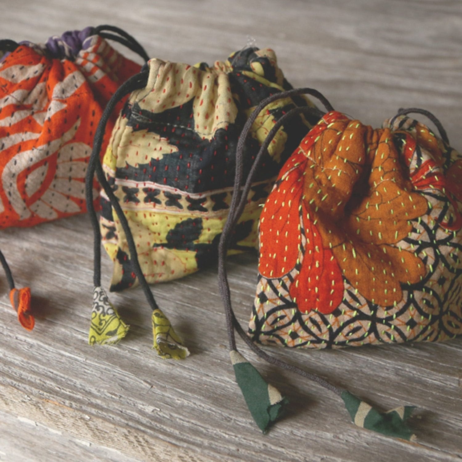 Top view of a handmade sari gift bag showcasing vibrant recycled fabric and drawstring closure