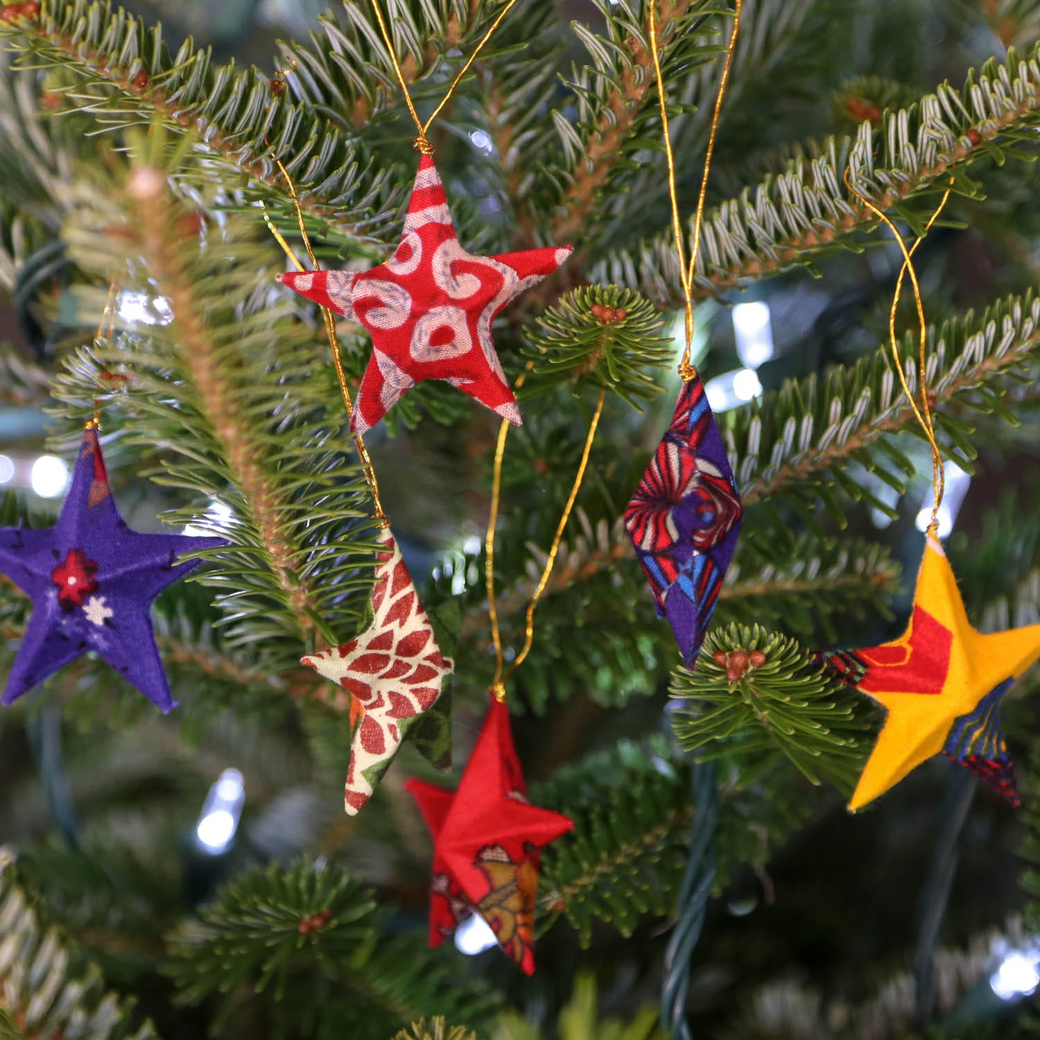 Handmade sari star ornament photographed on rustic wooden surface