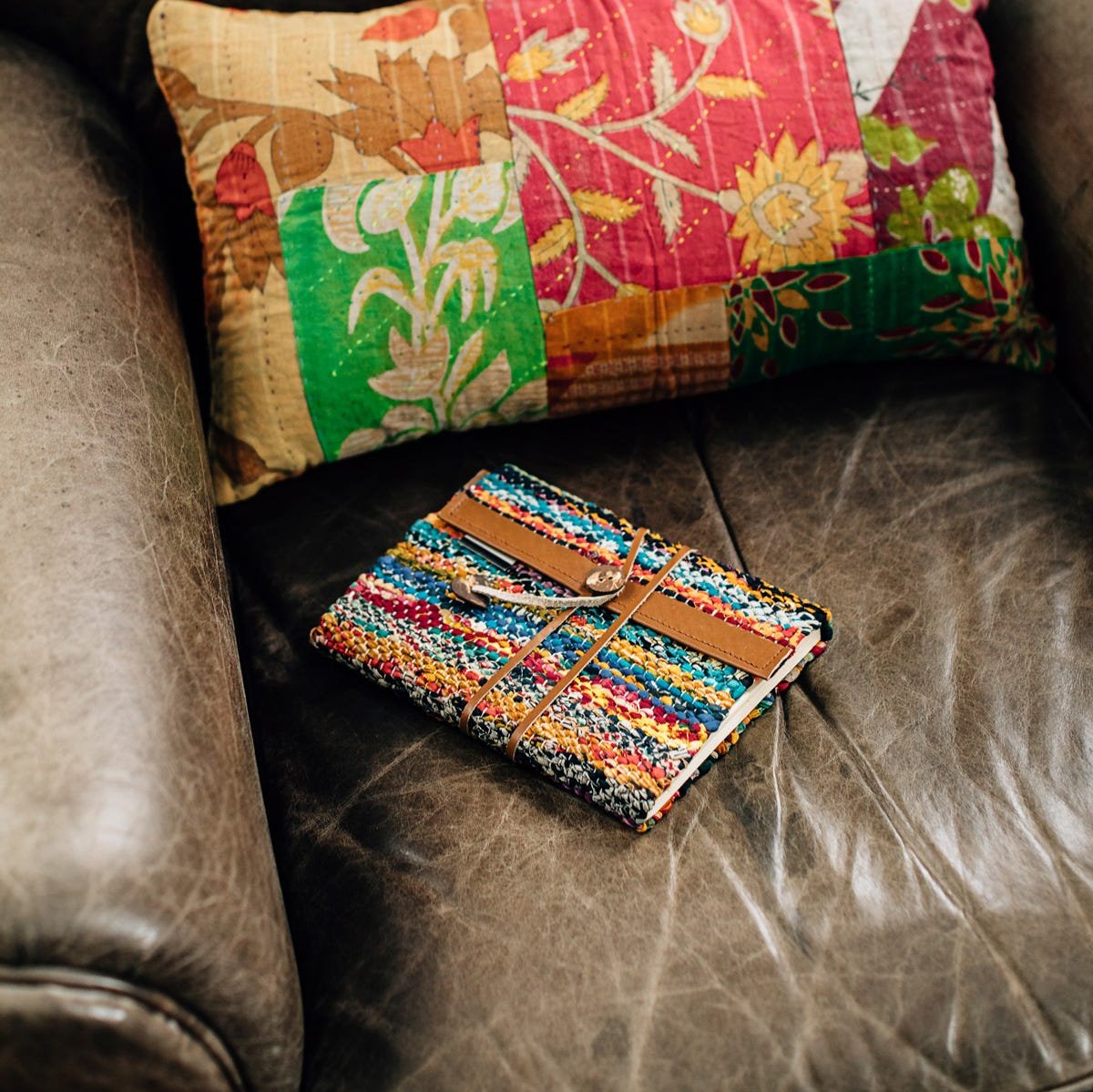 Close-up of sari cloth woven into the leather cover of a handmade travel journal