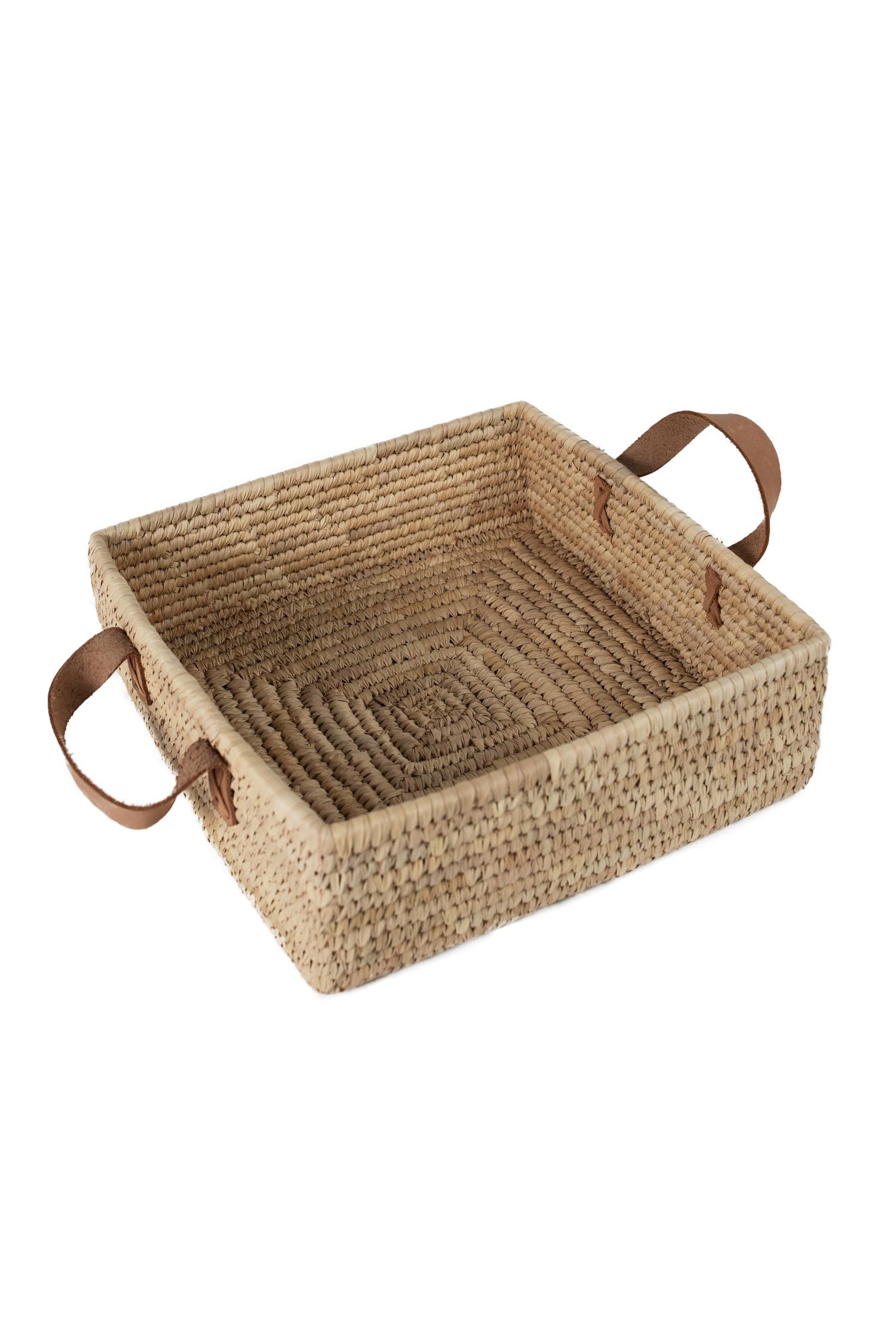 Side view of Artisan Square Handled Woven Basket filled with decorative items.