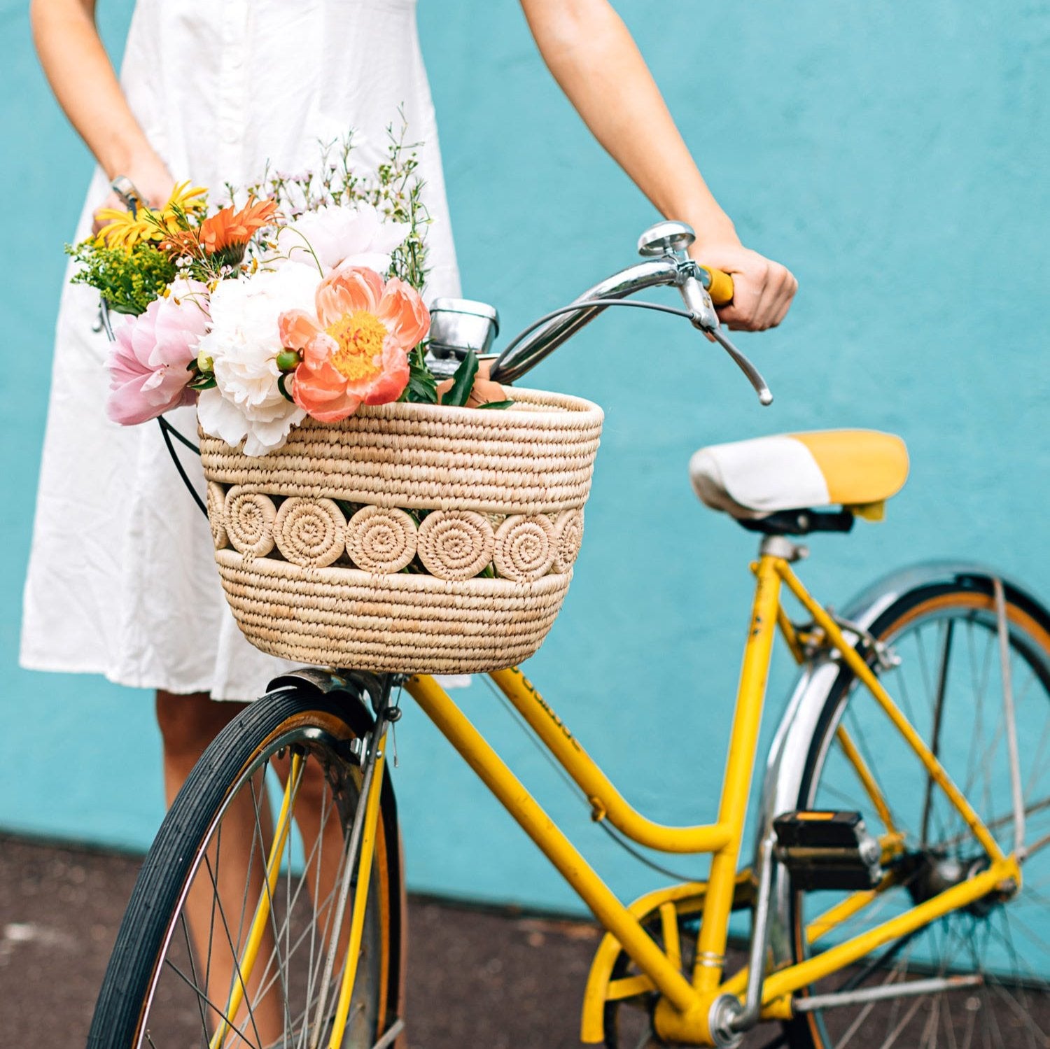 Close-up of handwoven palm leaf bike basket showing detailed weaving