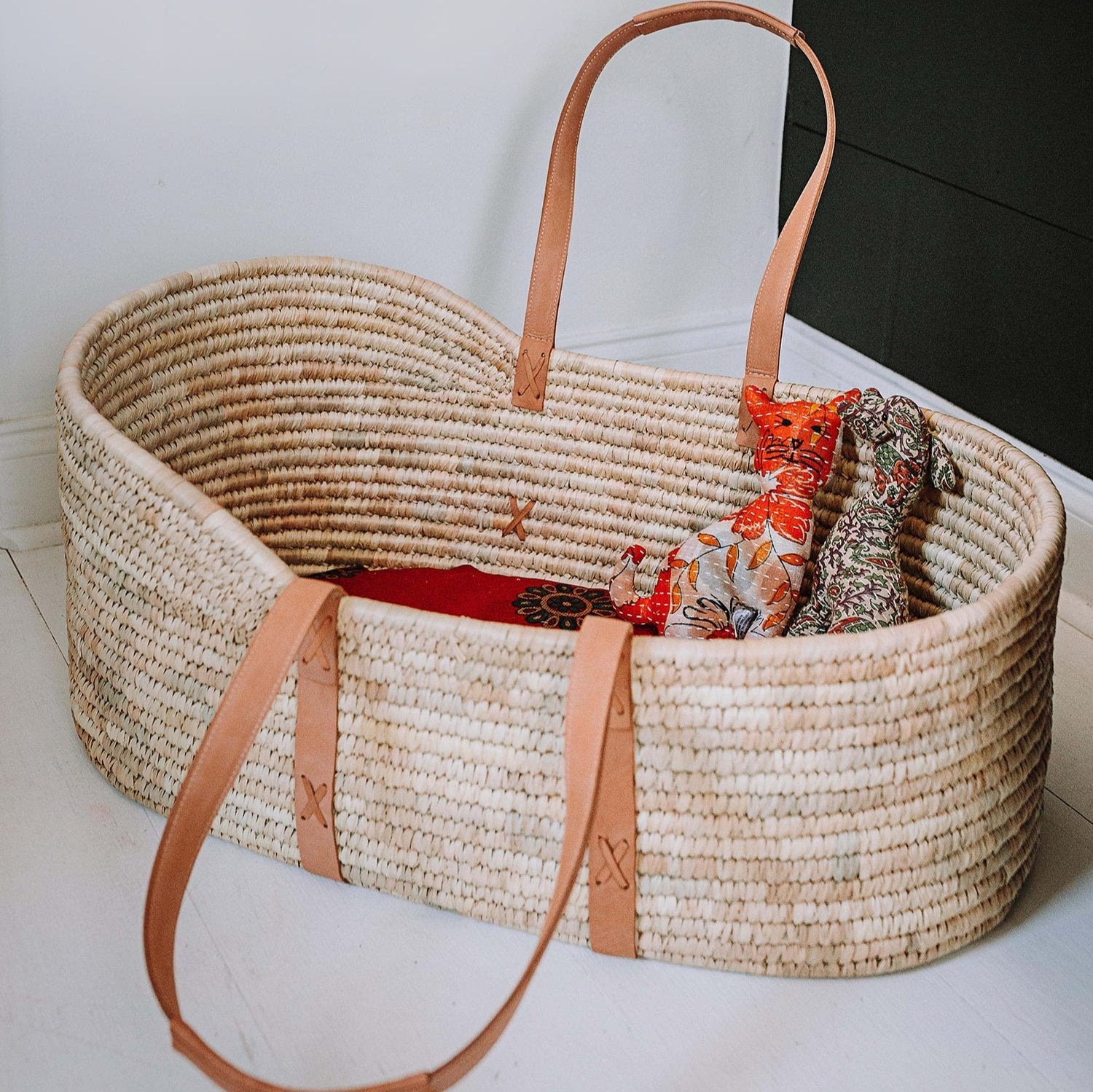 Close-up of woven palm leaf Moses basket for newborns, highlighting craftsmanship and natural materials