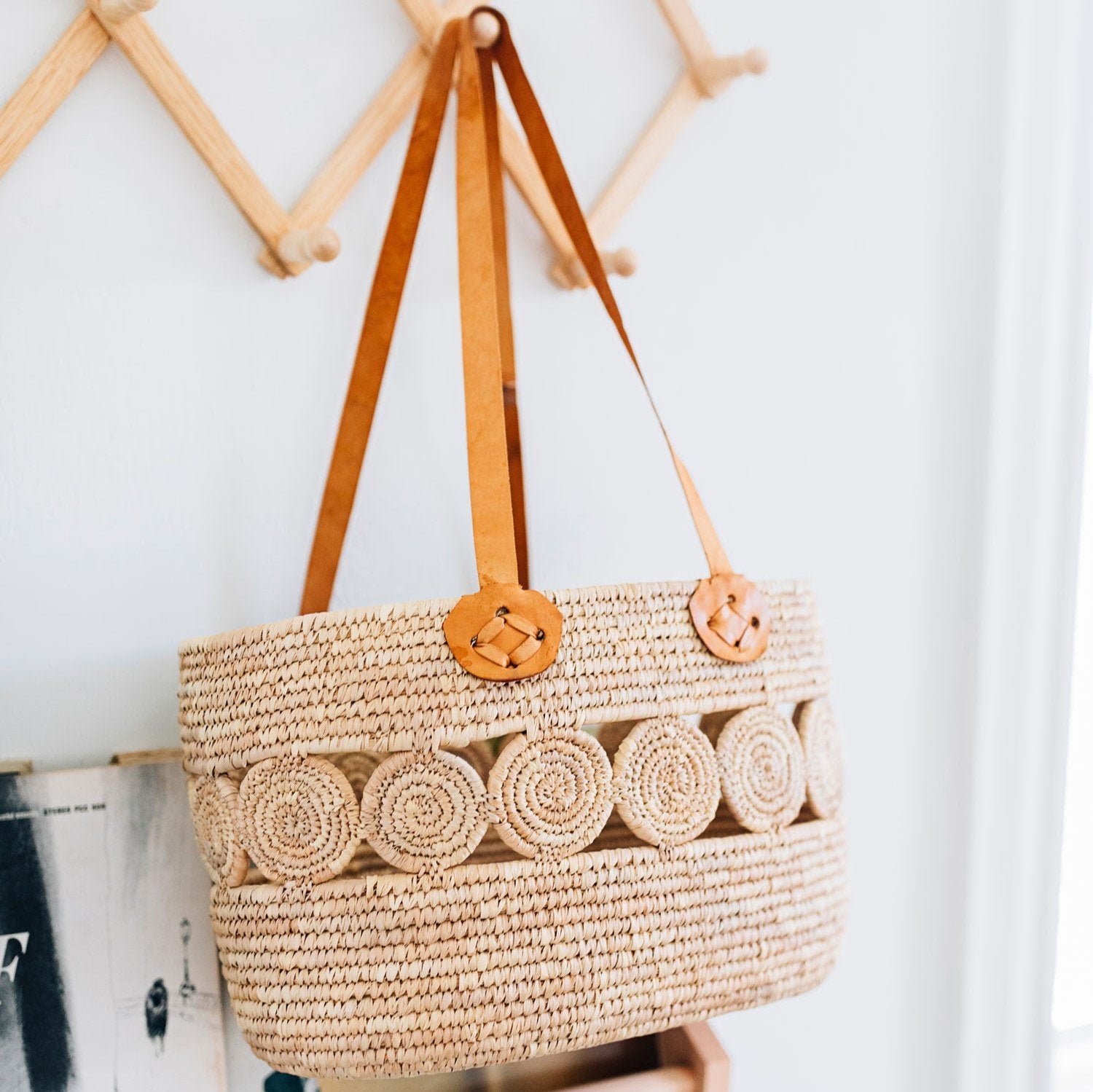 Artisan handwoven market tote with intricate design displayed at the beach, showcasing its versatility.